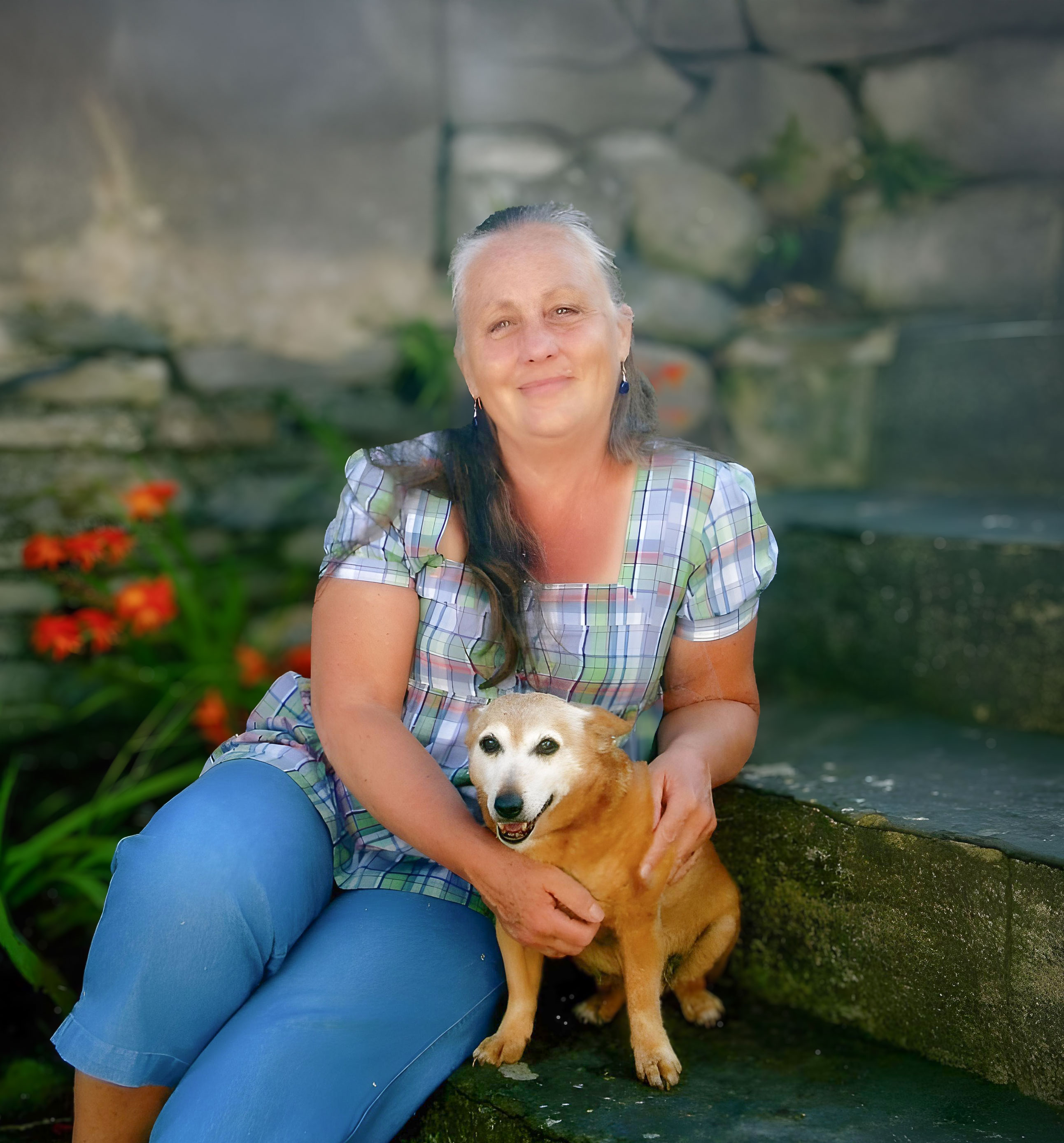 Carol Statham sitting on stairs with dog