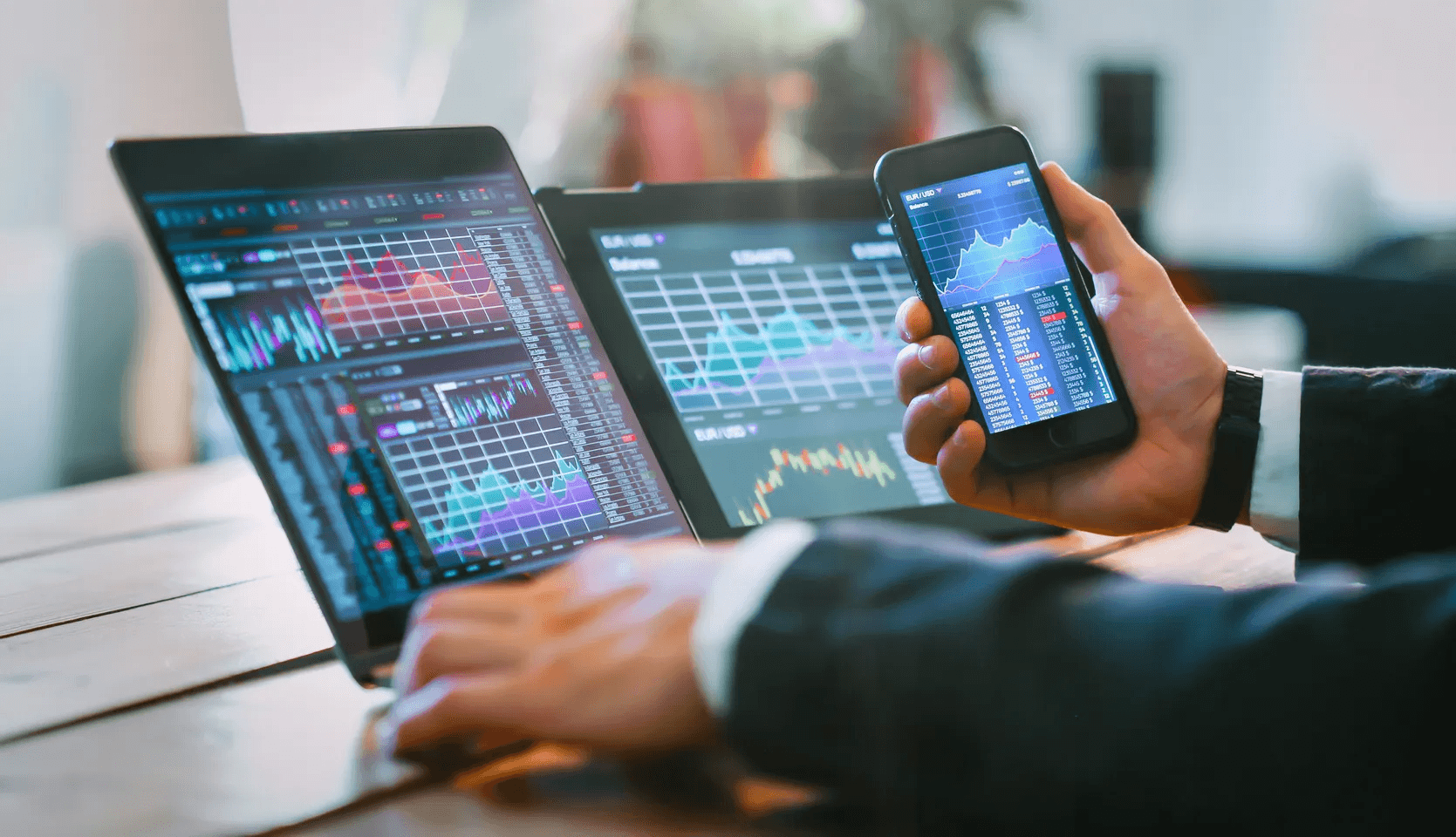Man analyzing financial data across devices - How Old Do You Have to Be to Invest in Crypto