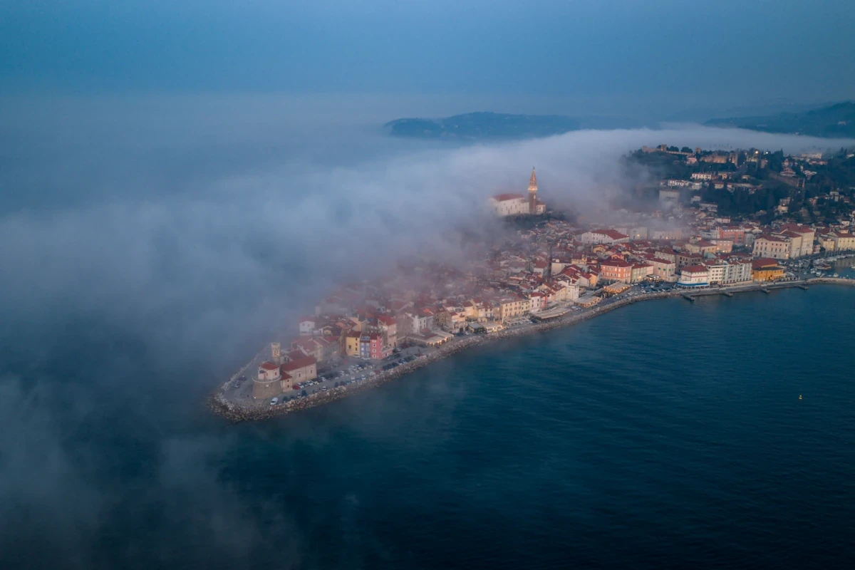 Aerial view over Piran town in Slovenia, schrouded in mist.