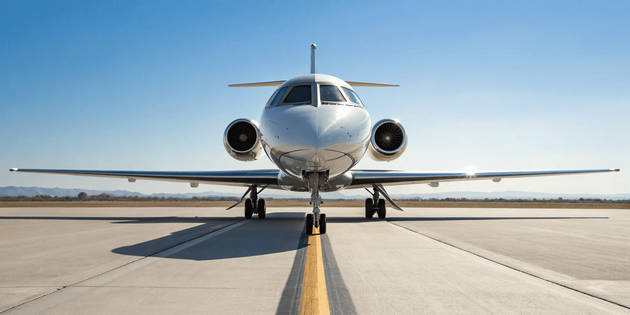Luxury private jet parked on the runway beside a black executive car, representing premium private aviation and seamless travel service.