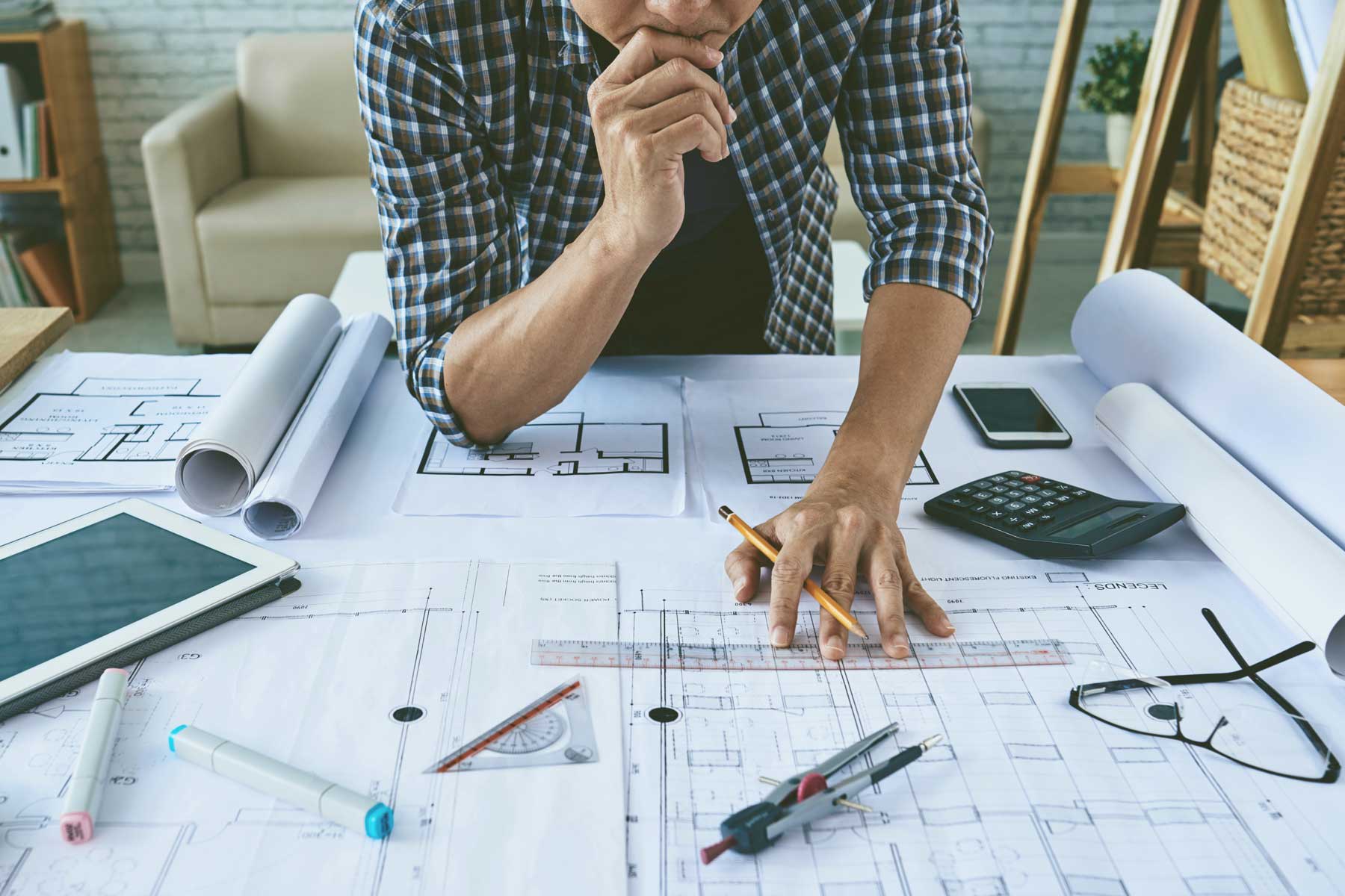 a man as architect looking to a sketch