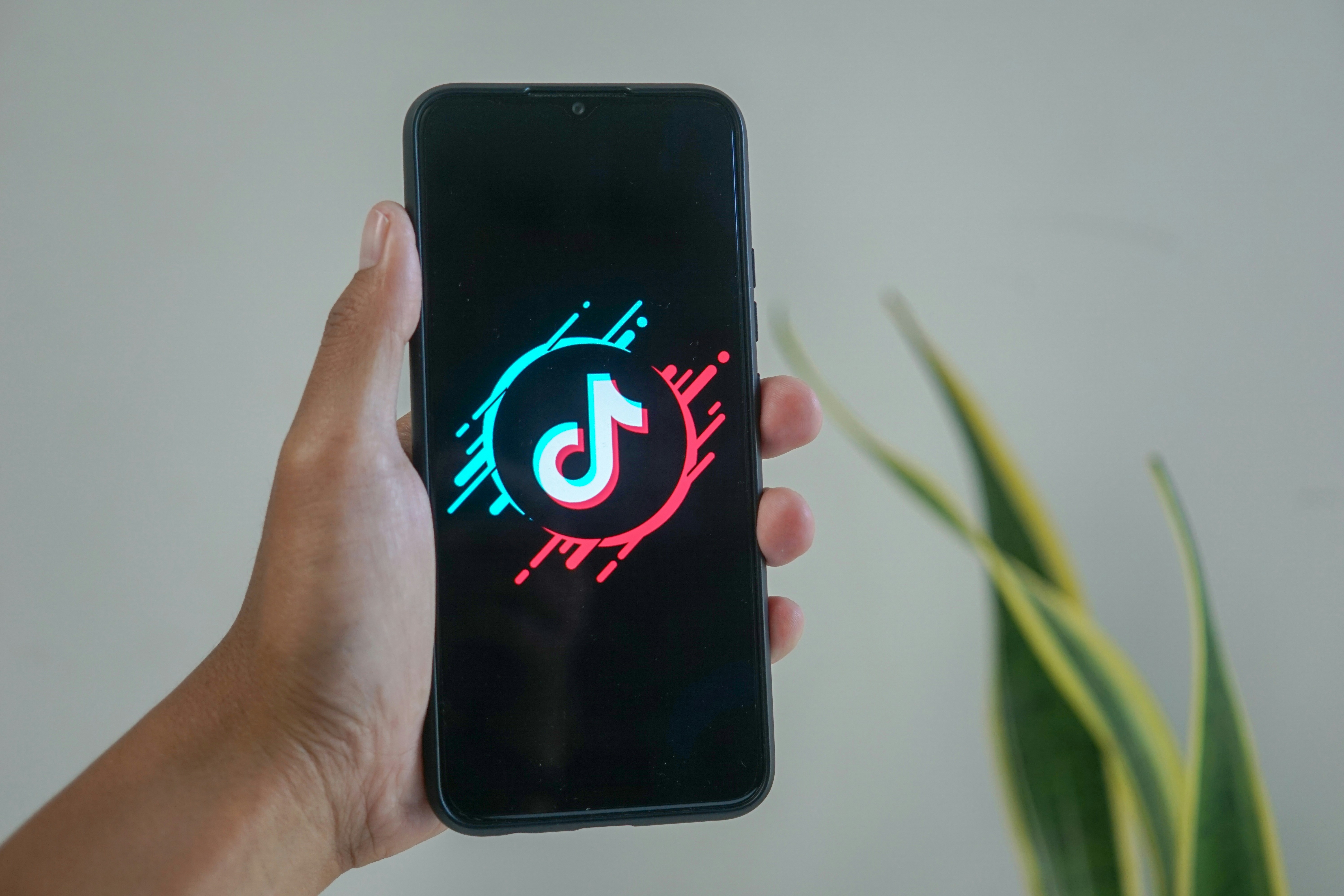 man launching up his tik tok app - How To Edit Tiktok Videos