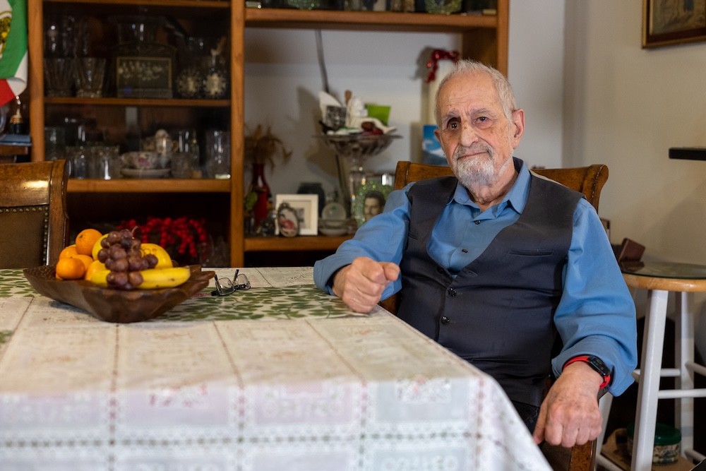 Bubjan with book and speaking to camera