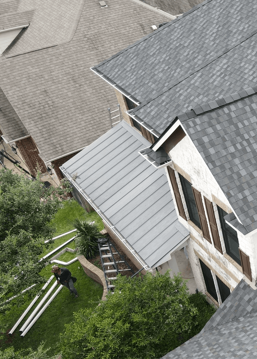 Our crew installing new 5 inch gutters on a house.