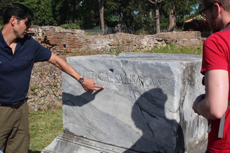 a man pointing at the stone