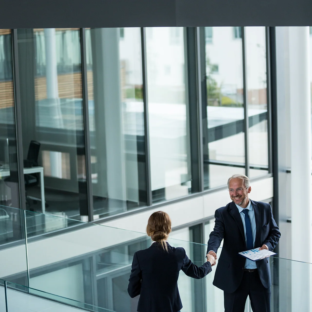 Two advisors shaking hands
