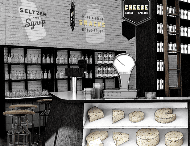 A black and white image shows a cheese shop interior with a curved counter displaying various cheeses on shelves below. A clock is mounted on the wall above the counter. Behind the counter are shelves filled with bottles and glassware. Two bar stools are positioned to the left of the counter. The wall behind the shelves features painted signage reading “Seltzer and Syrup” and “Nuts & Seeds Snacks Dried Fruit.” A black sign reading “Cheese Sauces Specials” hangs above the counter.