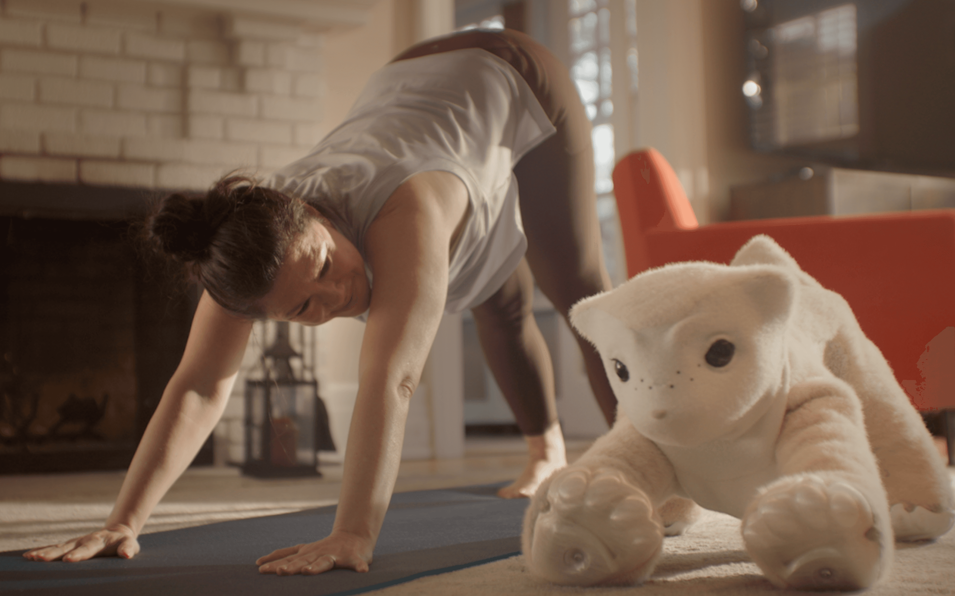 Woman doing downward dog yoga pose beside a familiar