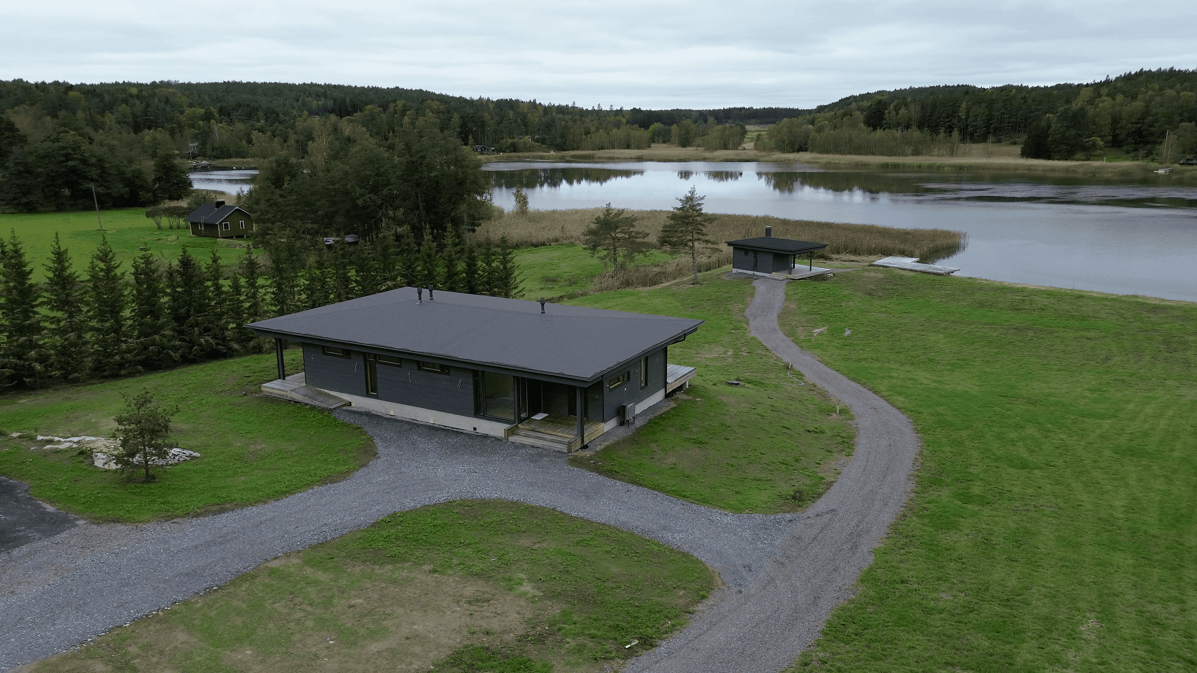 House and yard from above, sauna and sea in the background