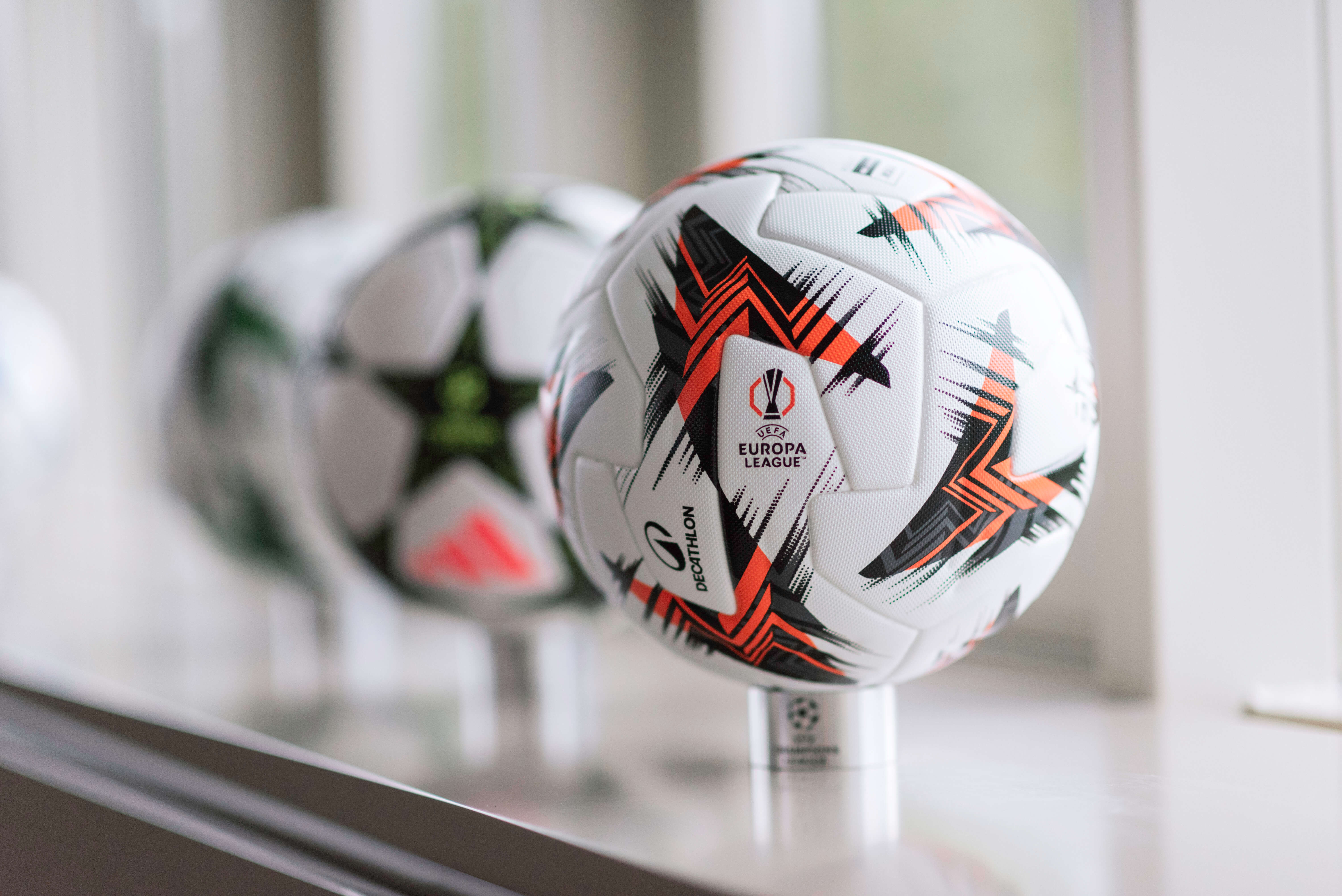 UEFA Europa League football displayed on a stand, highlighting Team’s involvement in sports marketing.