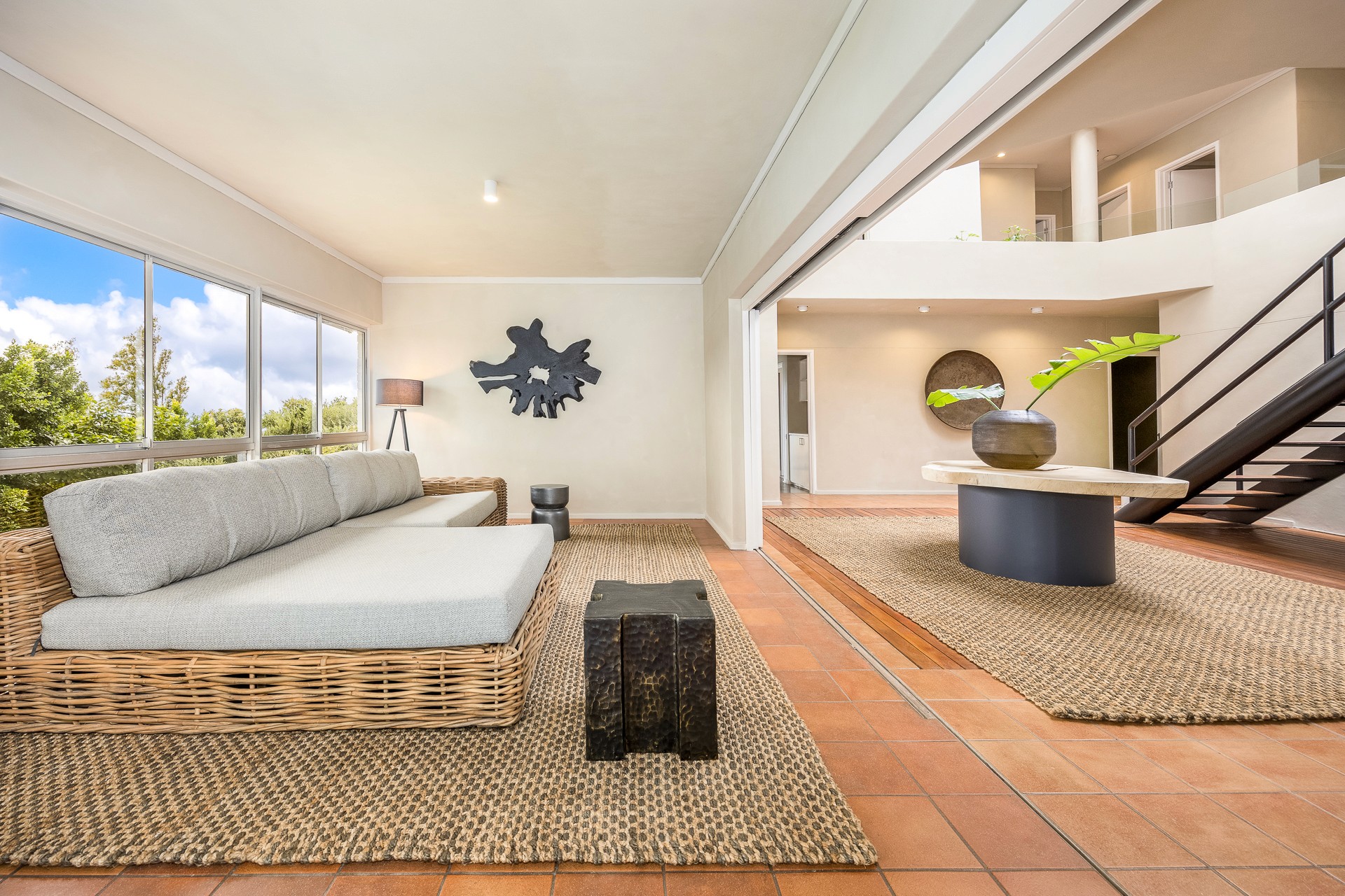 Looking up at several modern skyscrapers with glass facades against a clear blue sky, conveying a sense of ambition and urban magnificence.