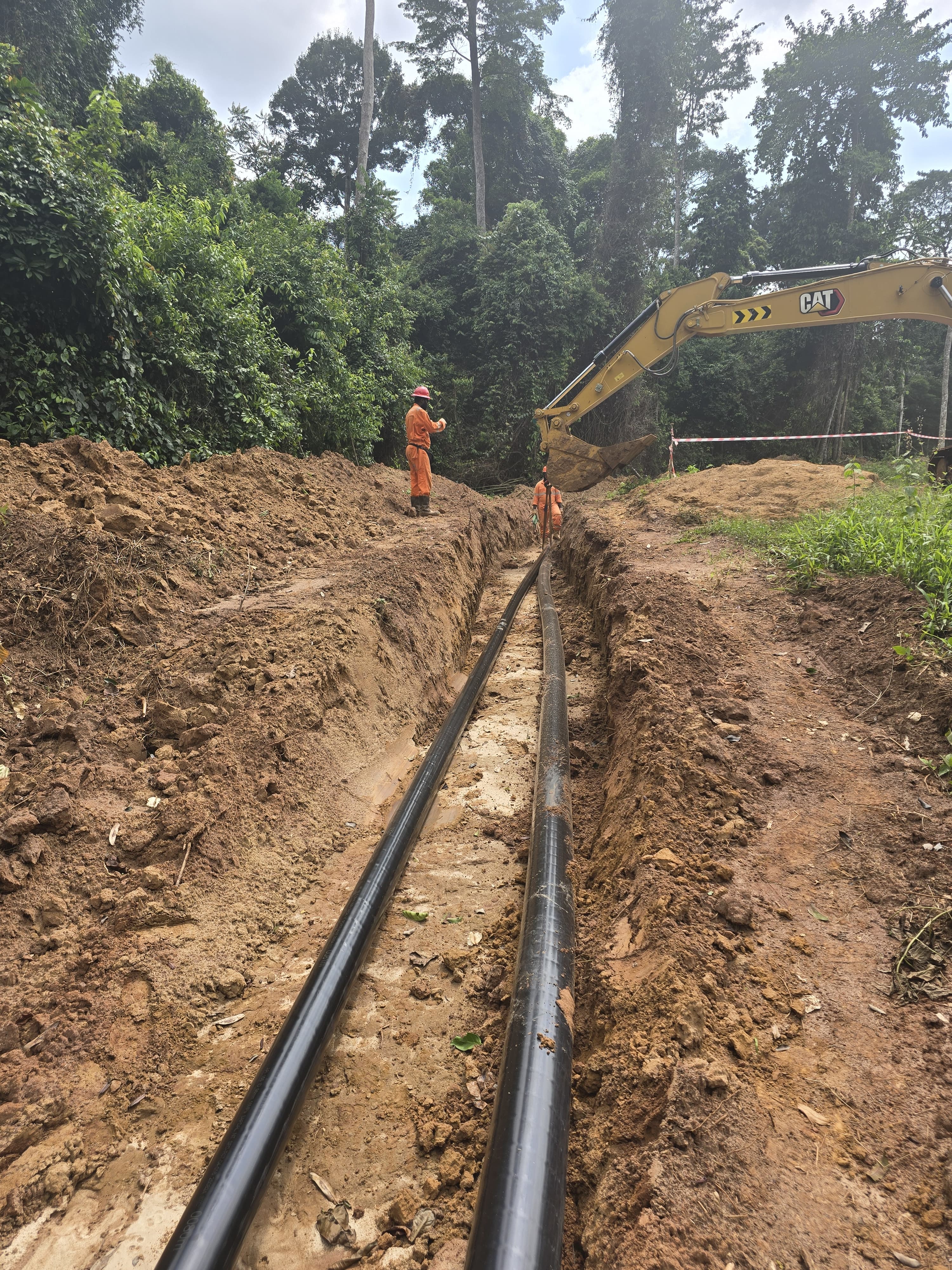 Reinforced thermoplastic pipe installed in trench for oil and gas flowline pipeline replacing traditional steel pipelines.