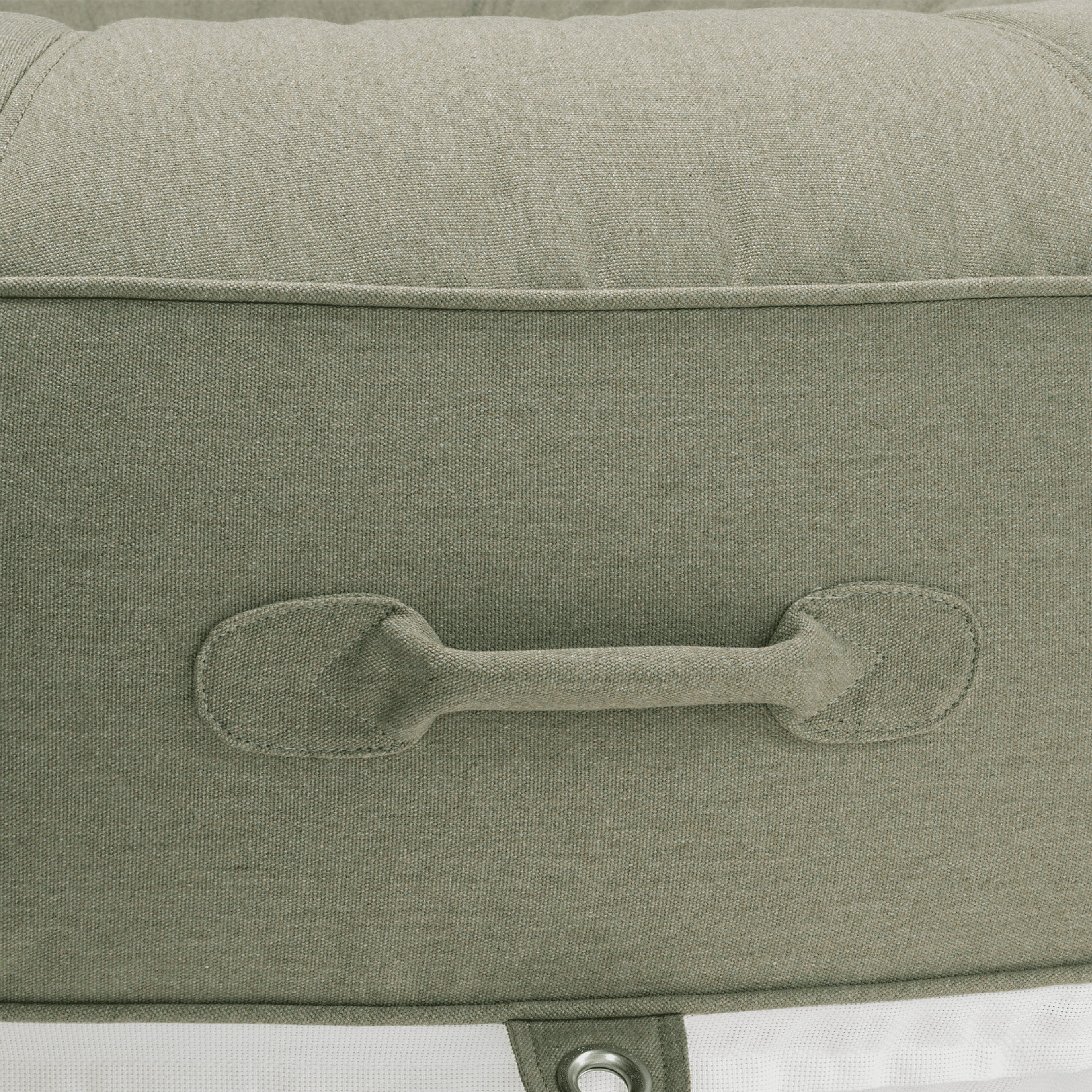 Close-up of a pool float showing green recycled canvas handle, colour-matched stitching, and stainless eyelet