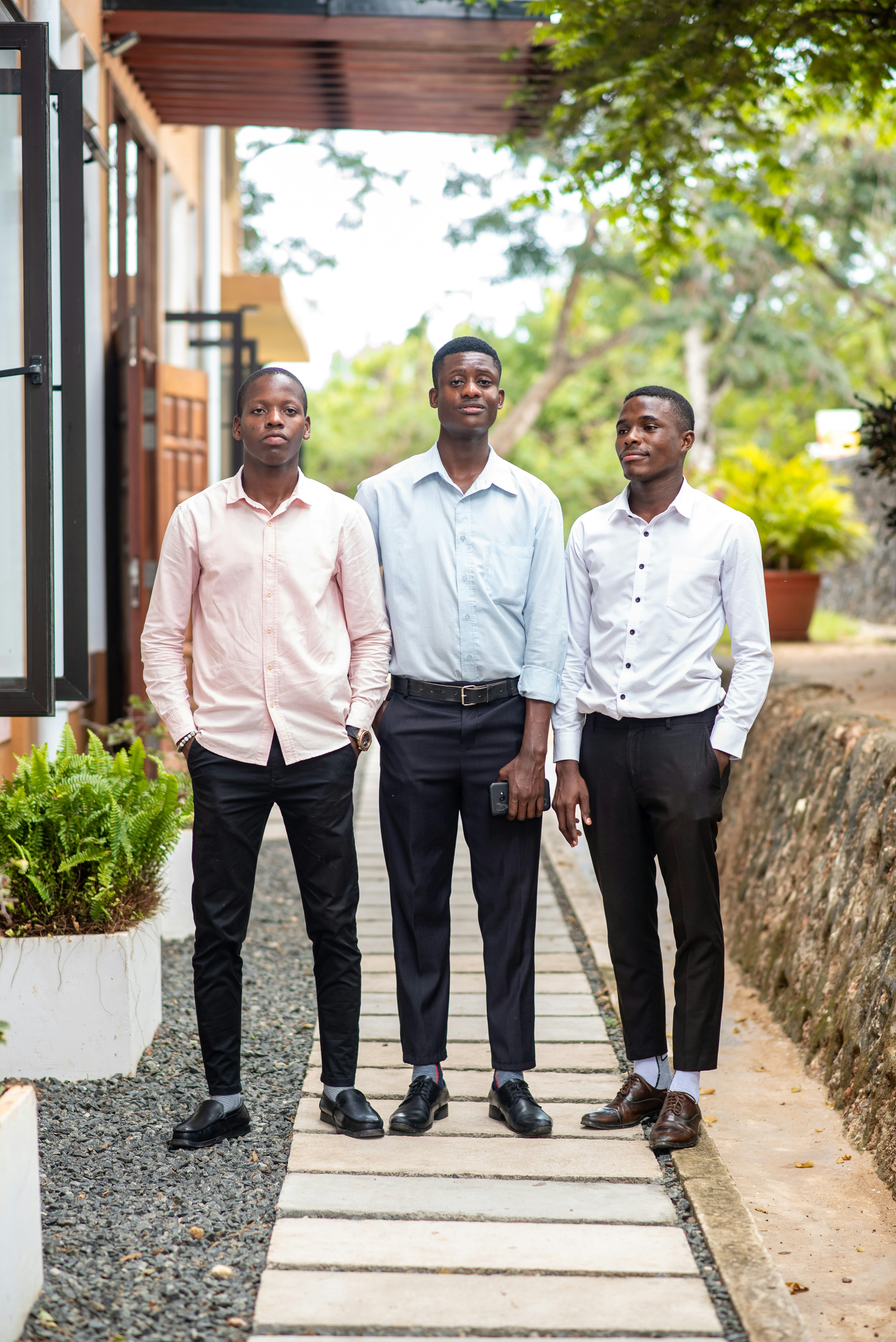 a group of three men standing next to each other
