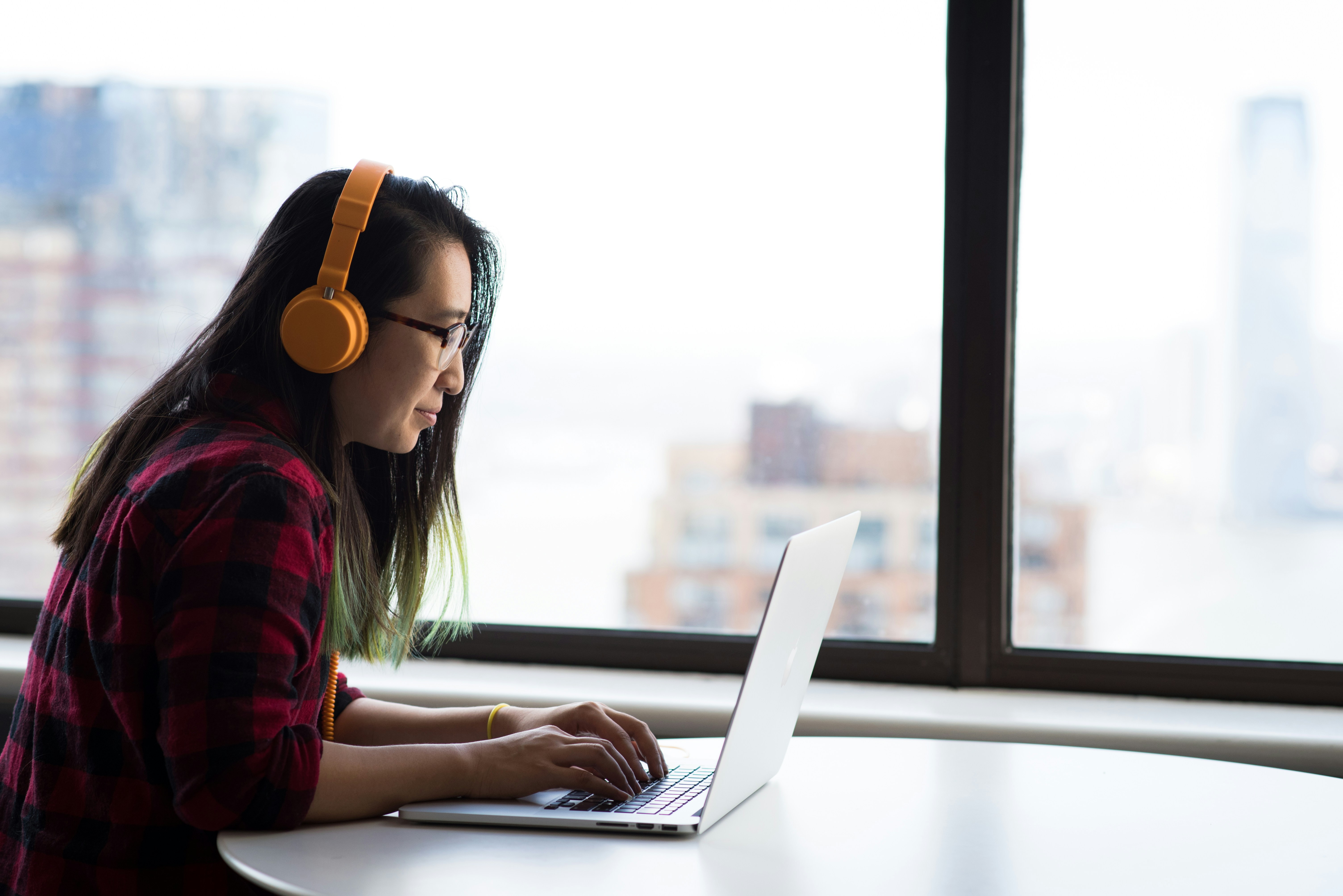 woman with headphones working - Essay Extender