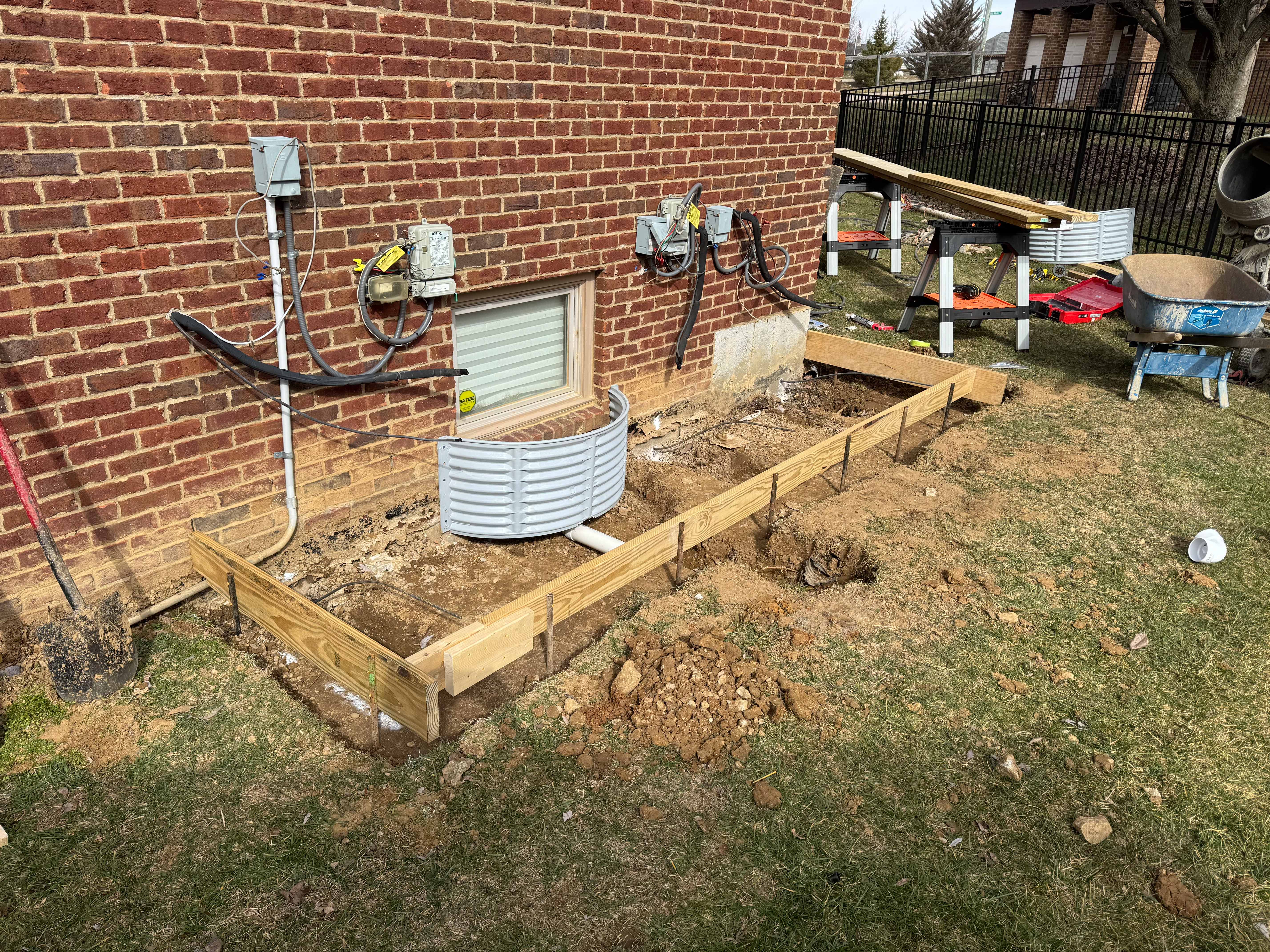 Wood framing around foundation window for concrete pad