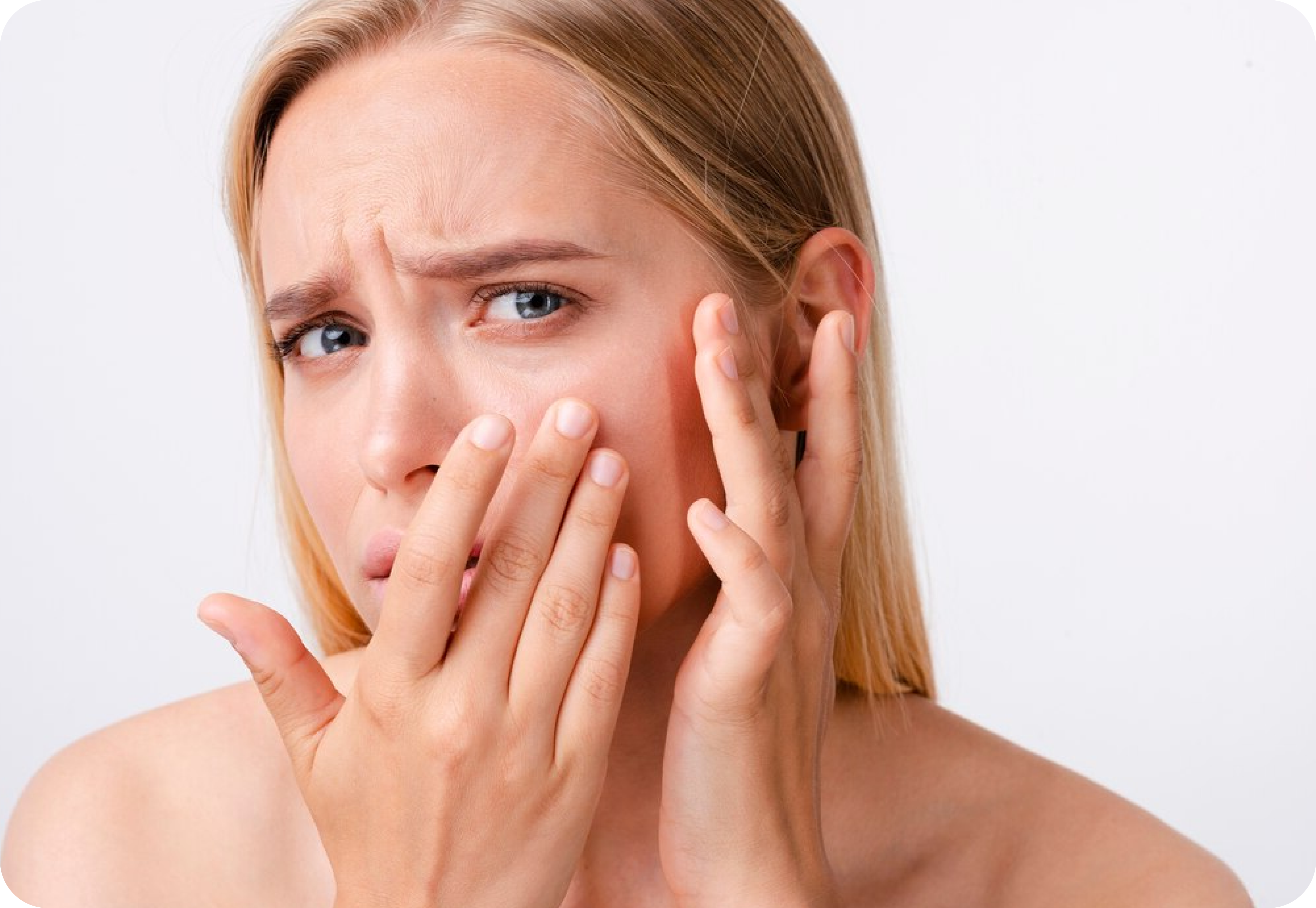 A woman with a concerned expression holding her cheek, indicating dental discomfort or pain