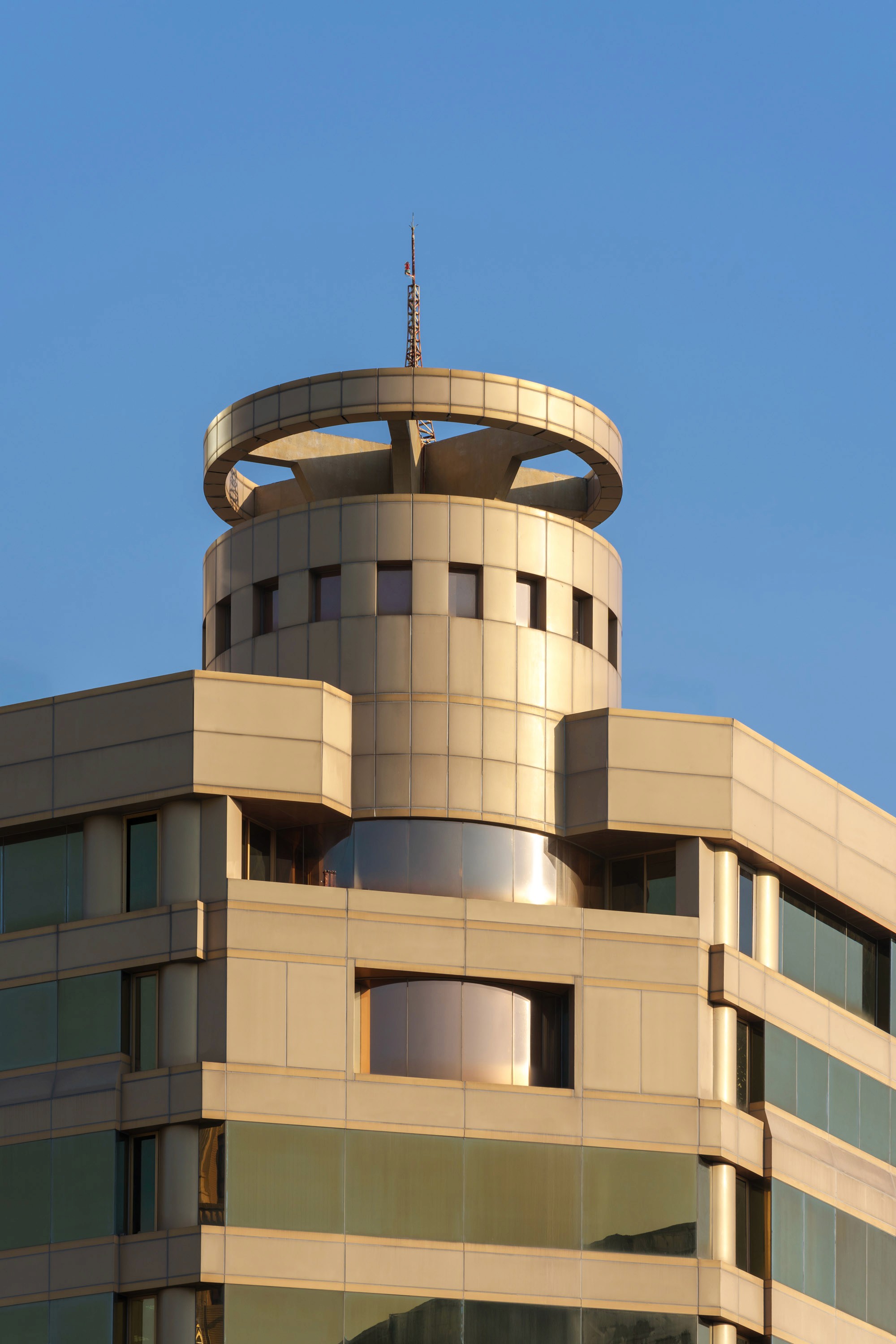 Daytime exterior view of a tower with tiered construction and a circular crown.