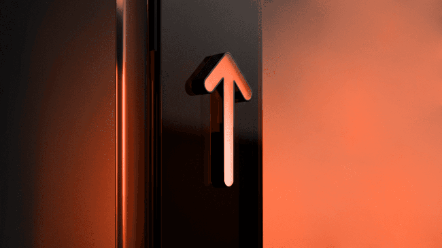 An upward arrow illuminated against a glowing orange background, symbolizing movement or direction.
