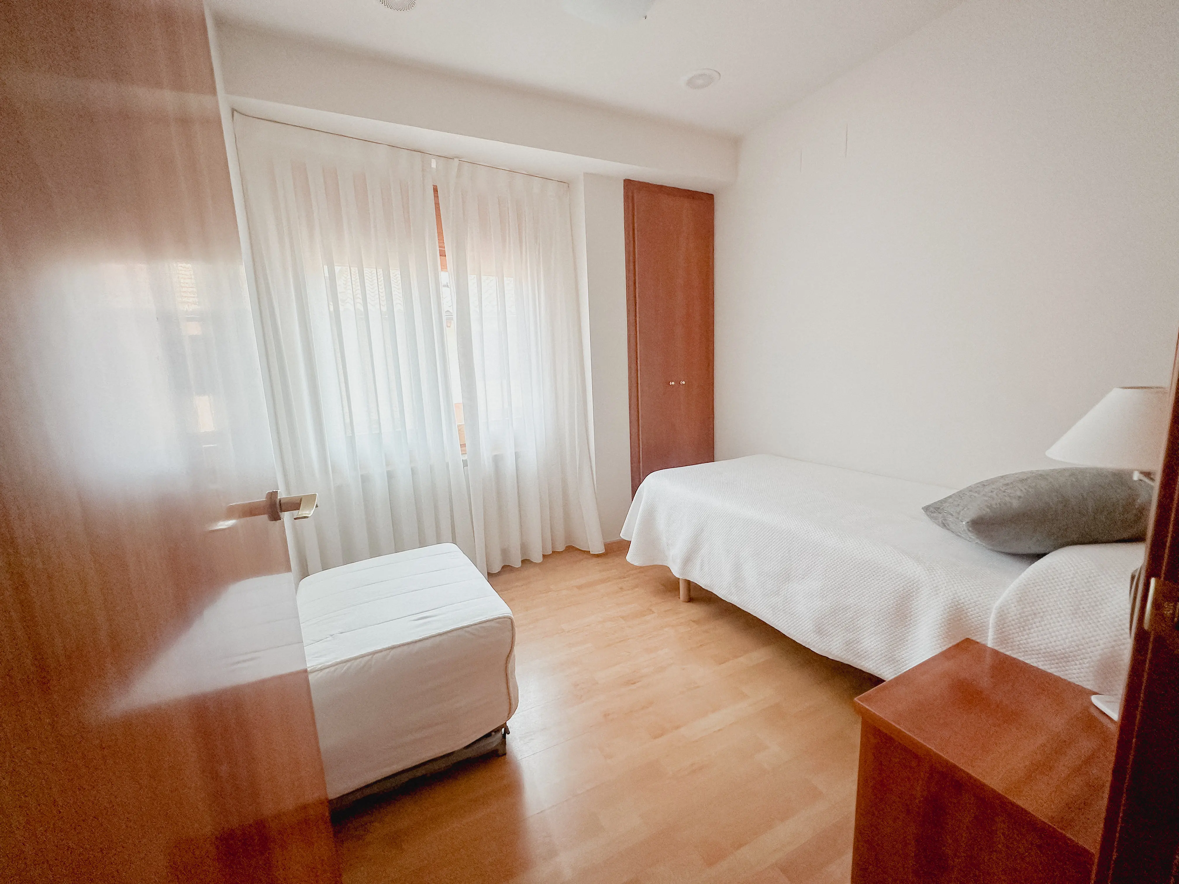 classy bedroom with white rooms, beige bed and blur grey duvet
