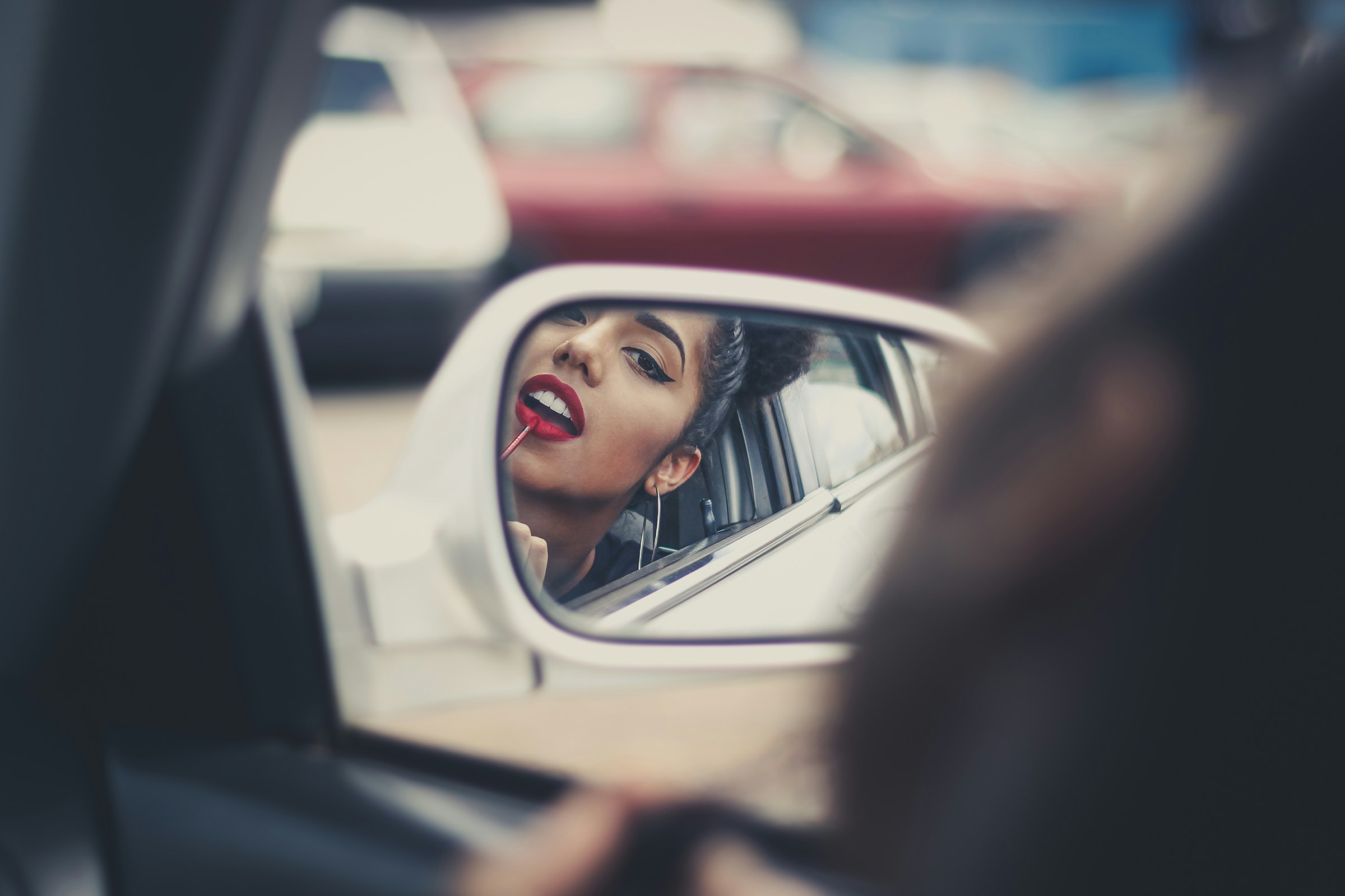 woman applying lip stick - Preppy Makeup