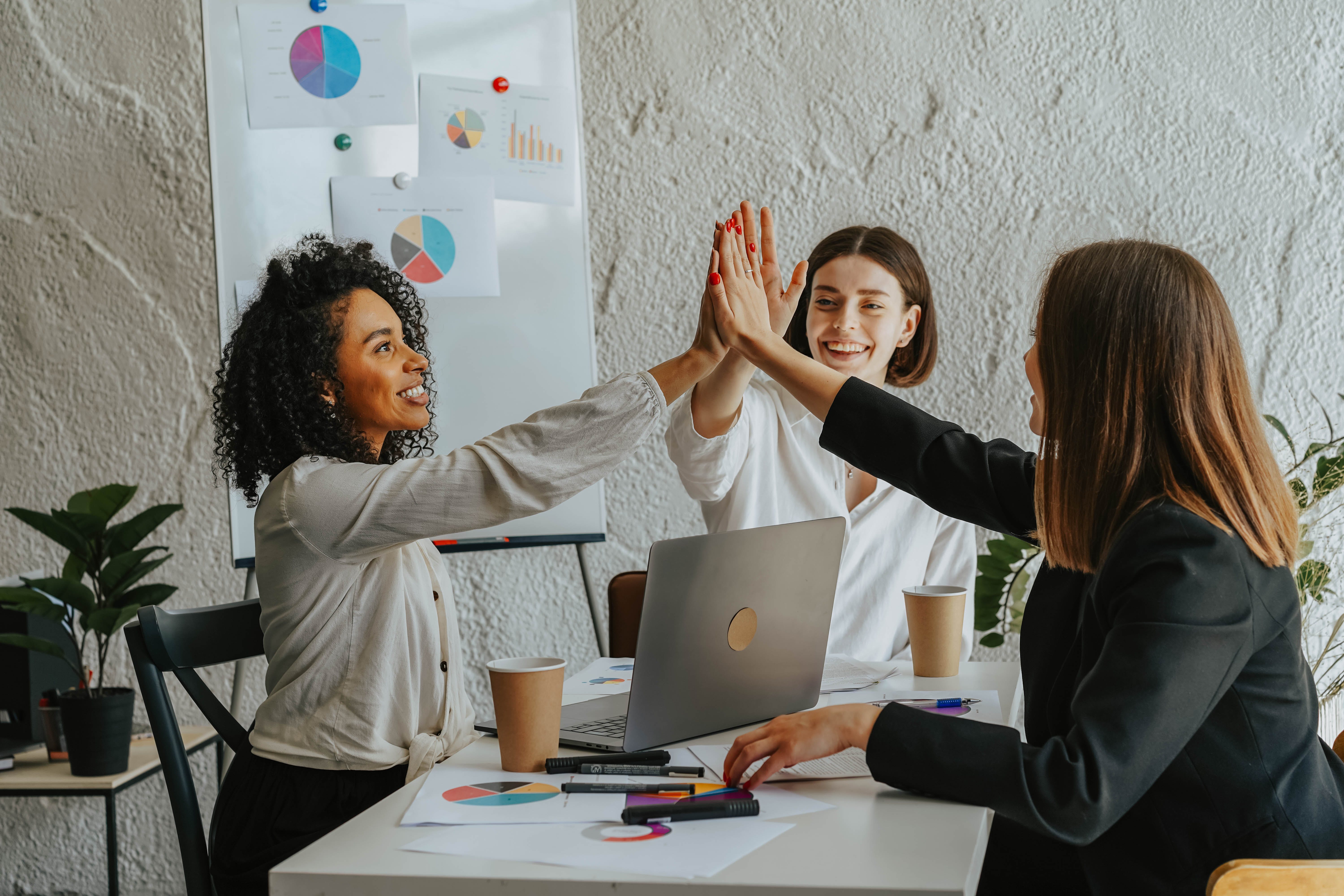 Women giving high five after receiving cold email success