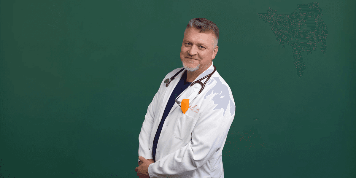 Dr. Brett Earl, a healthcare professional at Denali Specialty Clinic, dressed in a white coat with a stethoscope.