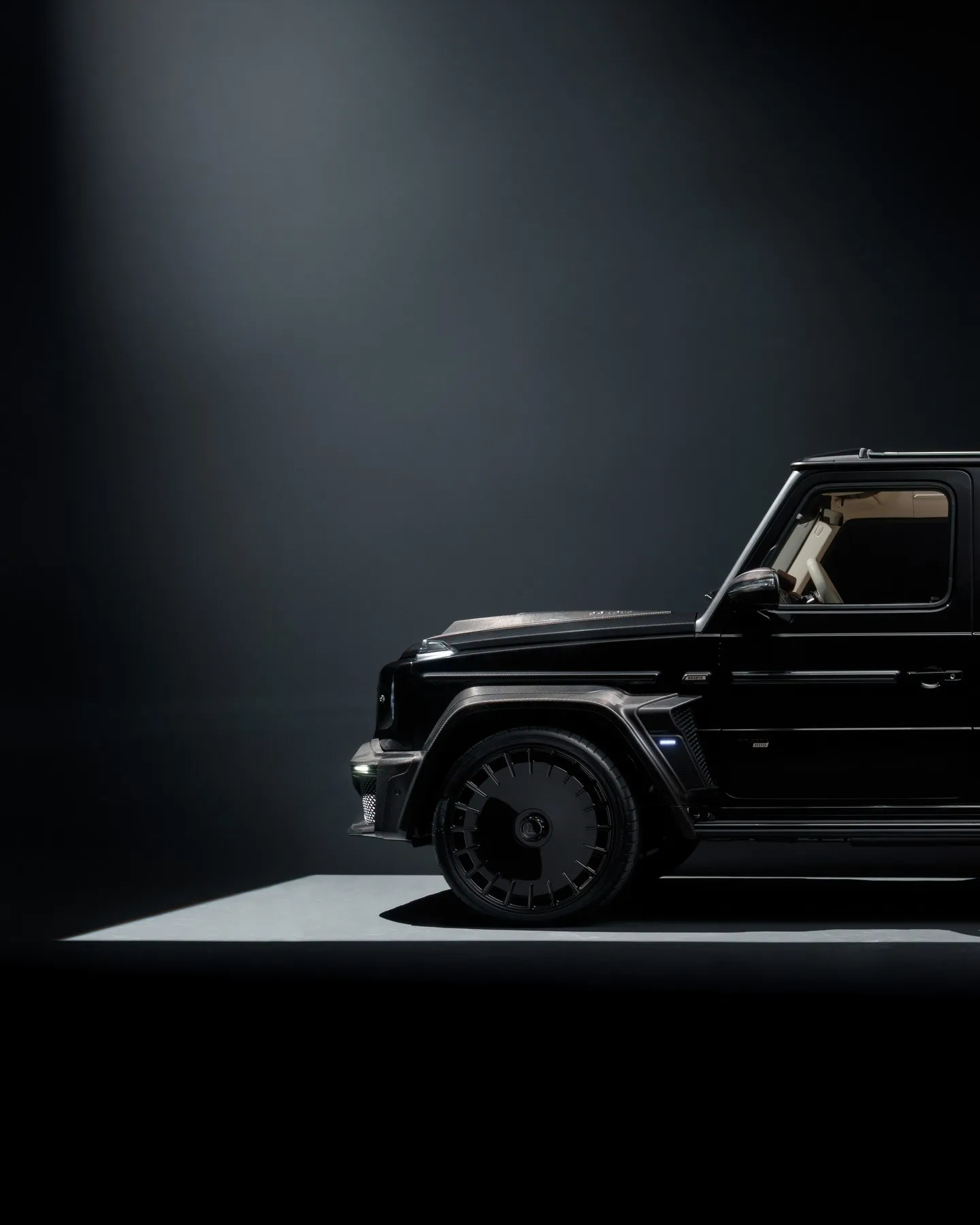 Person in dark clothing standing in moody, atmospheric lighting