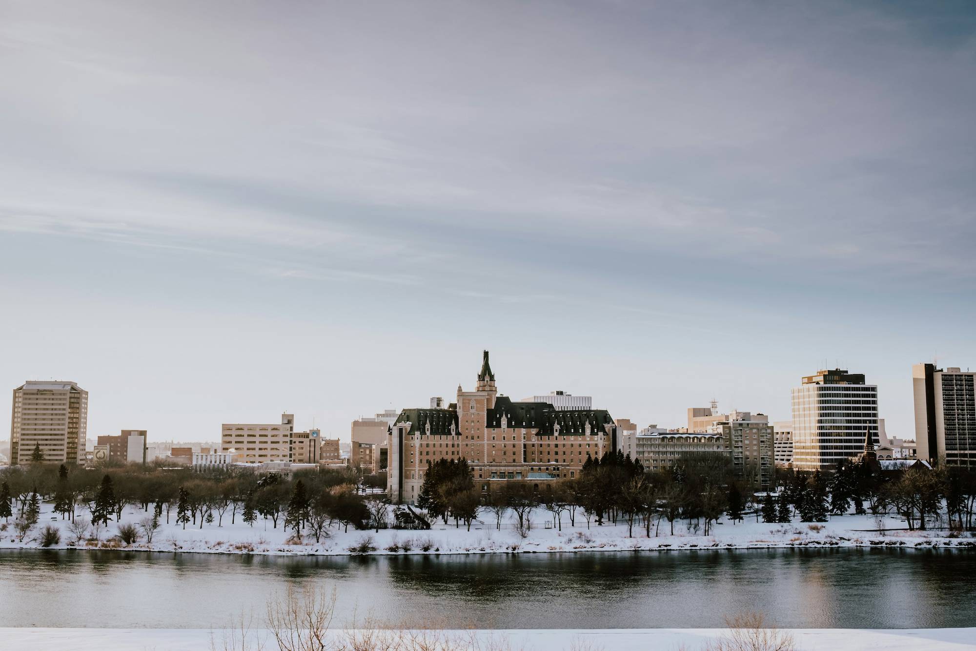 The Saskatoon City Skyline with a river in the foreground