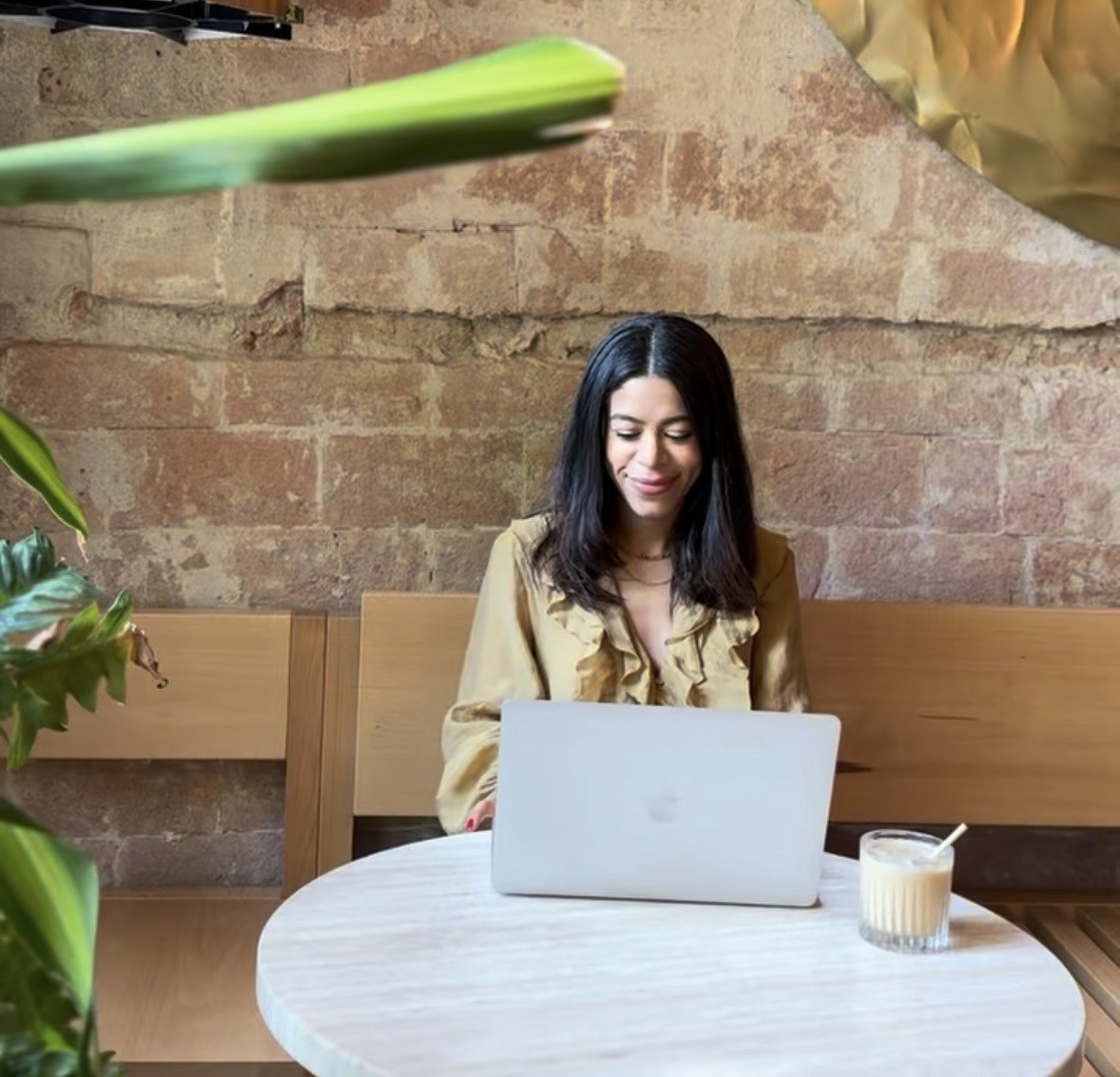 woman in black shirt holding white smartphone