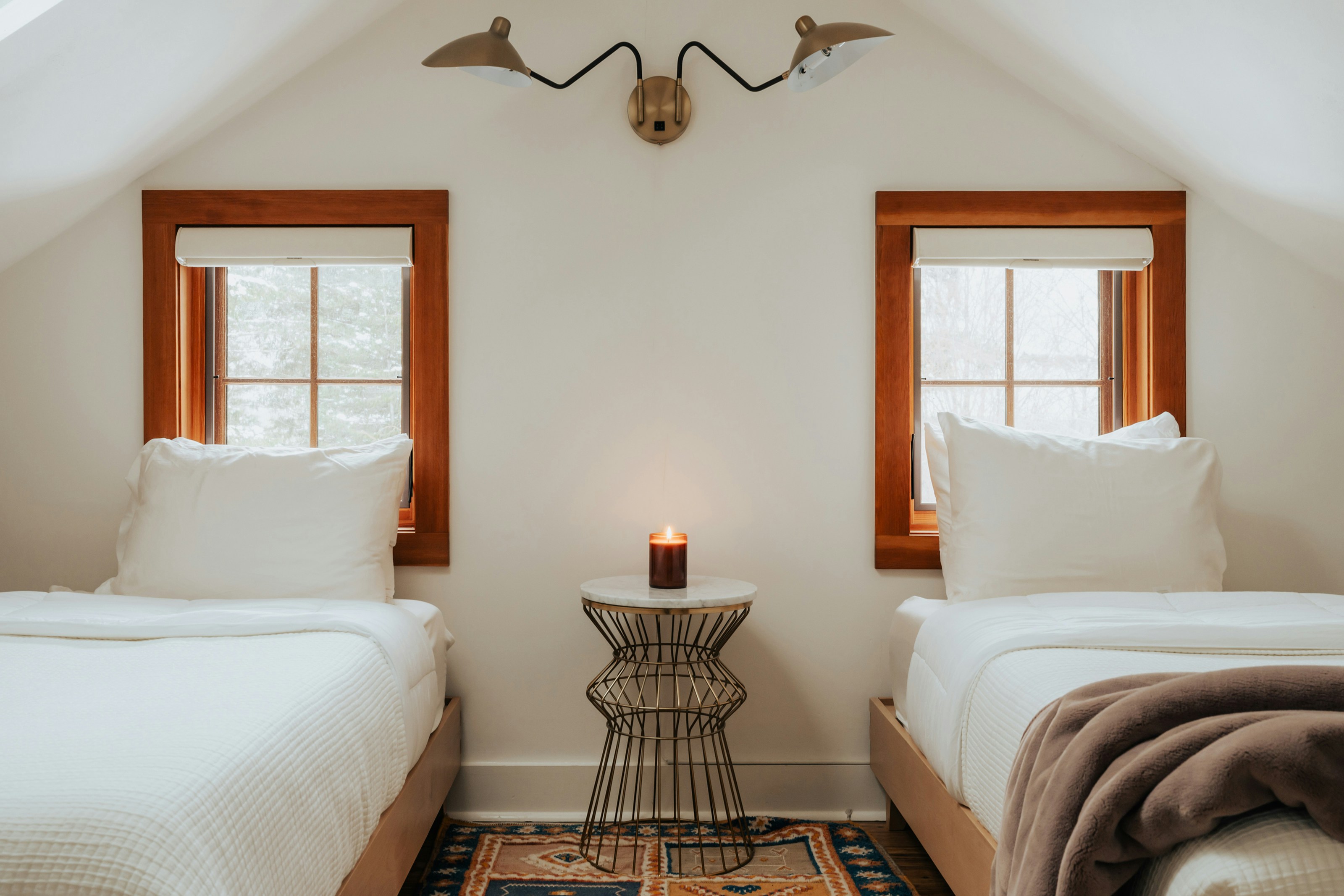 Two single beds side by side in a cozy hotel room.