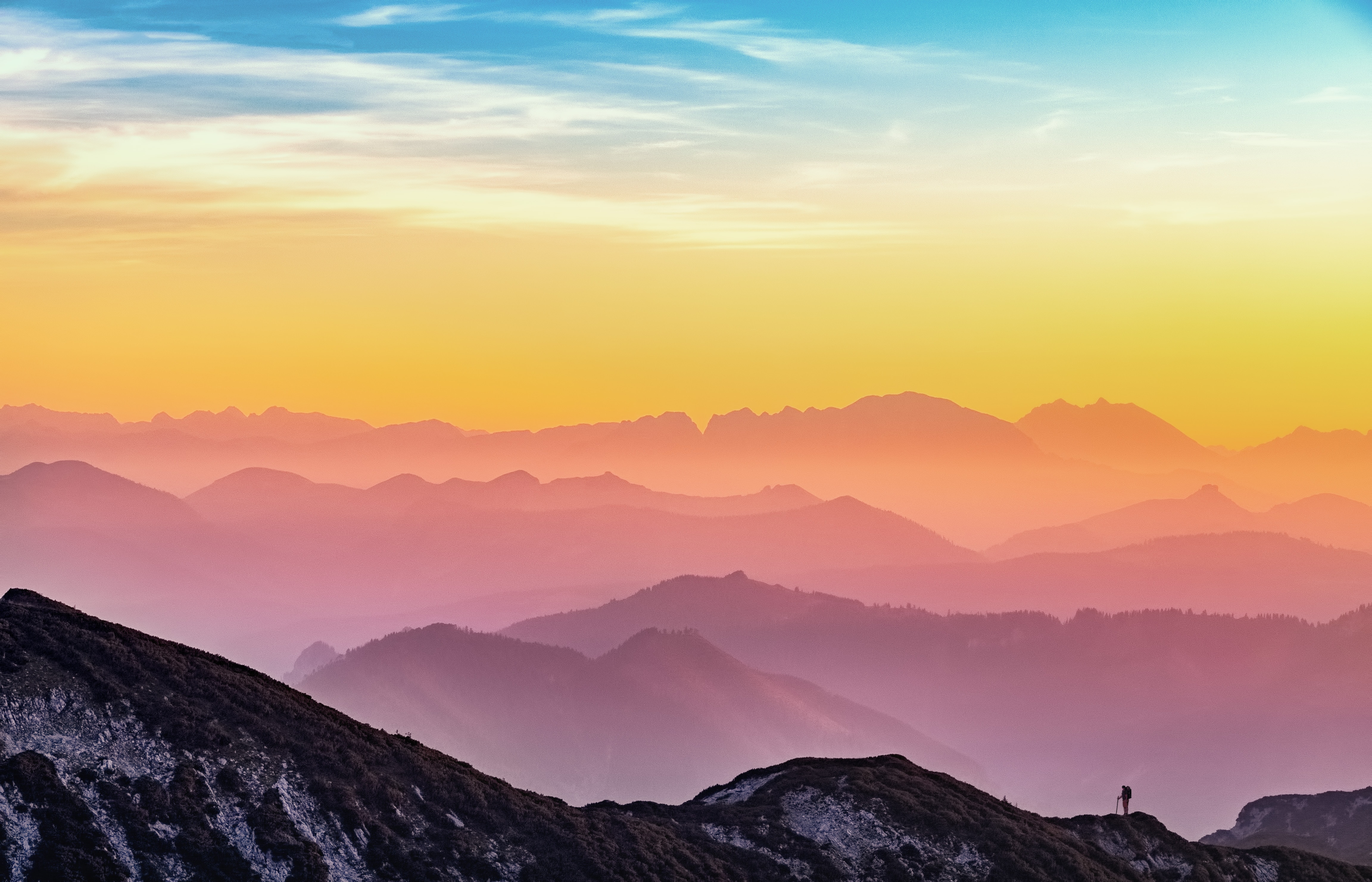 Mountain view with man standing on it after he retires from his text to singing career