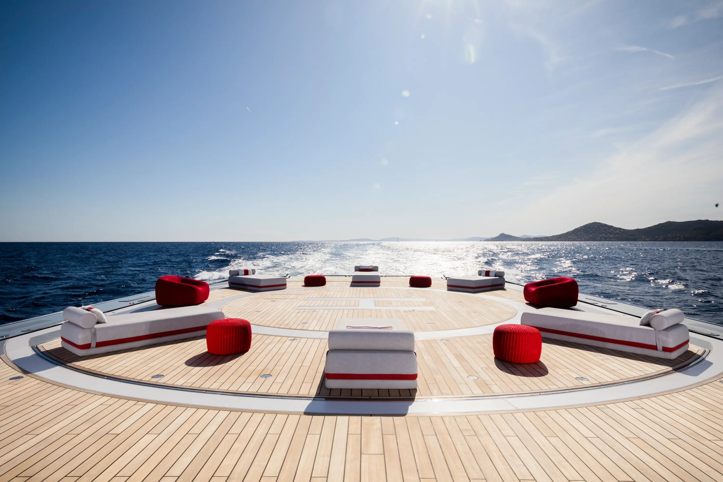 Modern living room with orange chair and plant.