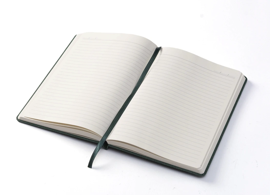 Open notebook displaying lined pages and green bookmark.