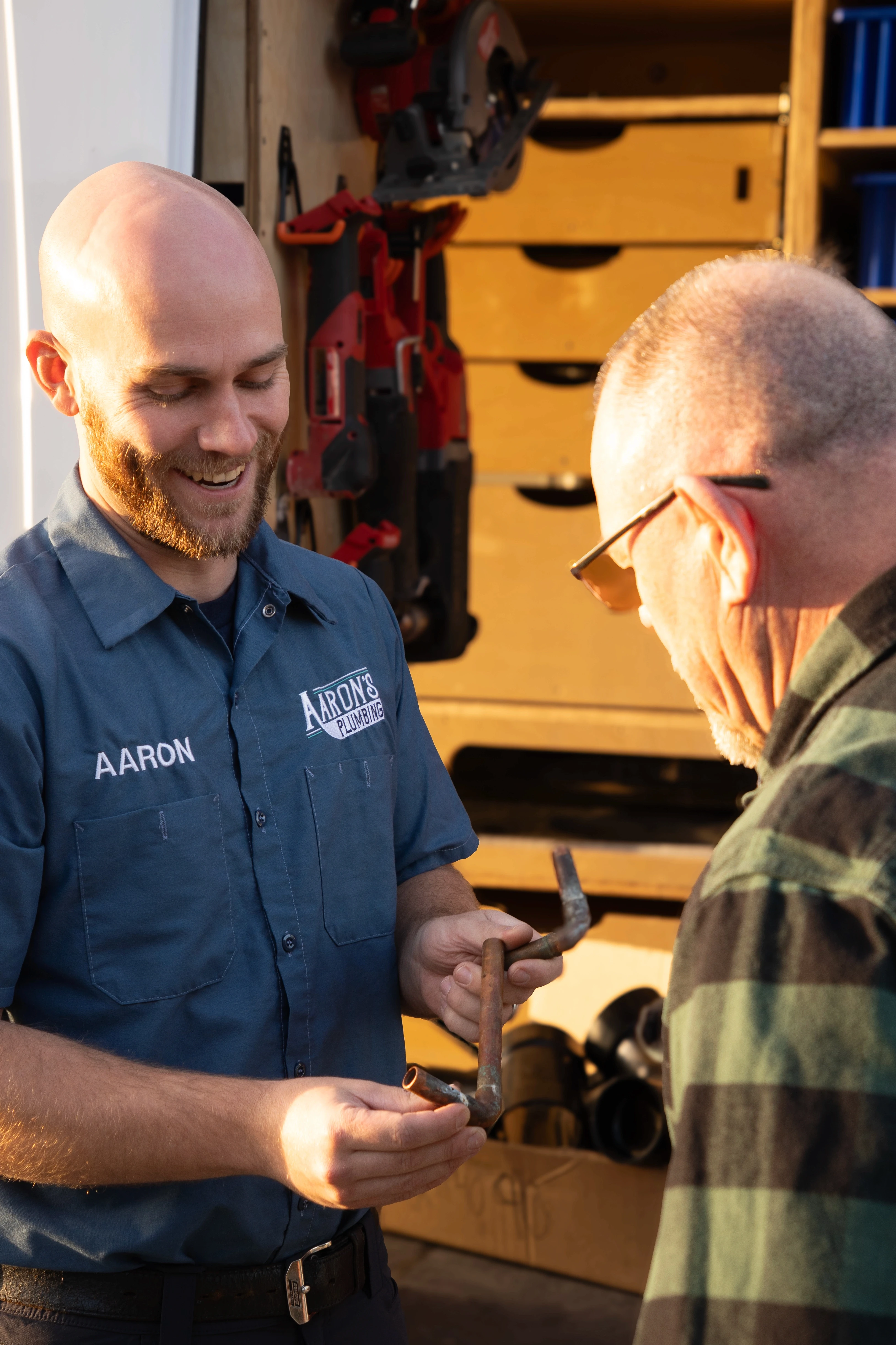 Licensed plumber Aaron Lindvall explains a detailed copper pipe repair diagnostic to a homeowner in Monterey County, CA.