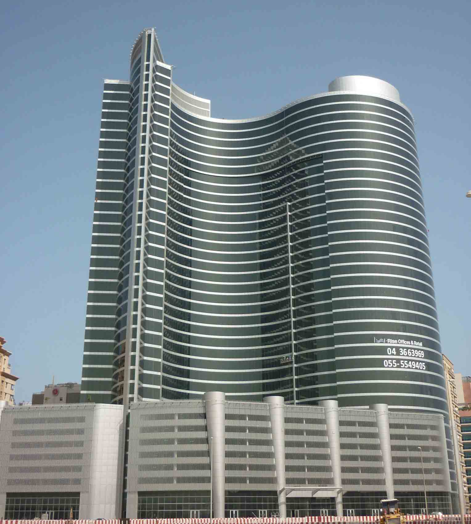 Wide angle of I-Rise Tower's unique architecture, a landmark for high-end corporate real estate services.