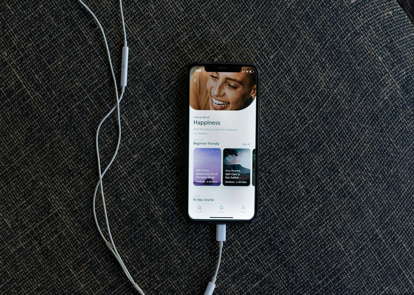 Alternative meditation apps - Homescreen of a wellness app on an iPhone