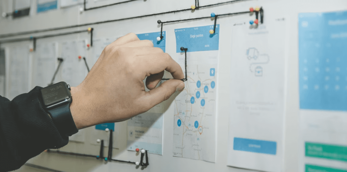 Hand holding a strategy on a whiteboard, project planning