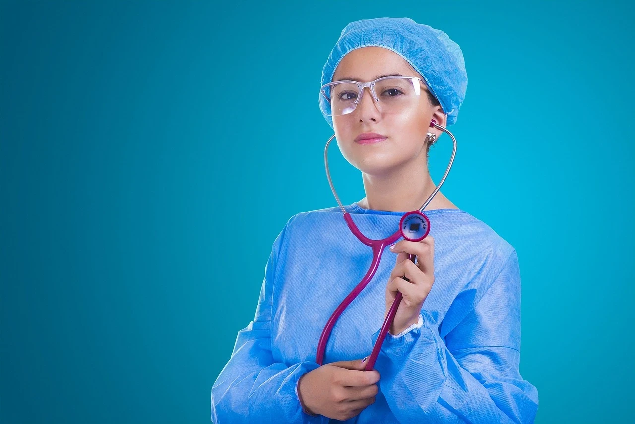 Young resident female doctor holding stethoscope.