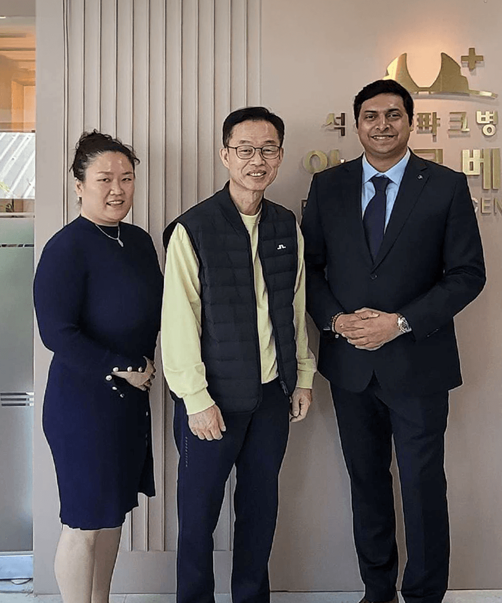 Beige interior with natural stone walls, sunlight, and geometric shadows over a calm water pool.