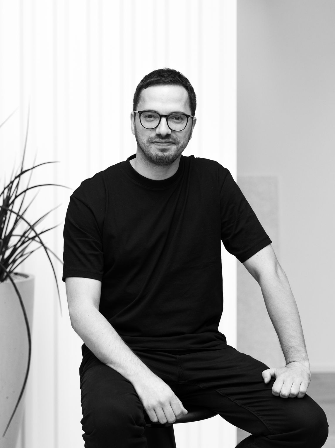 Man wearing traditional hat holds binoculars.