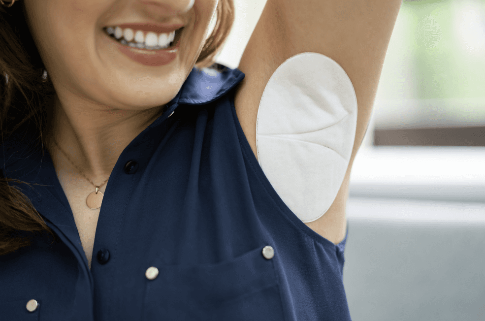 Woman wearing an underarm sweat pad