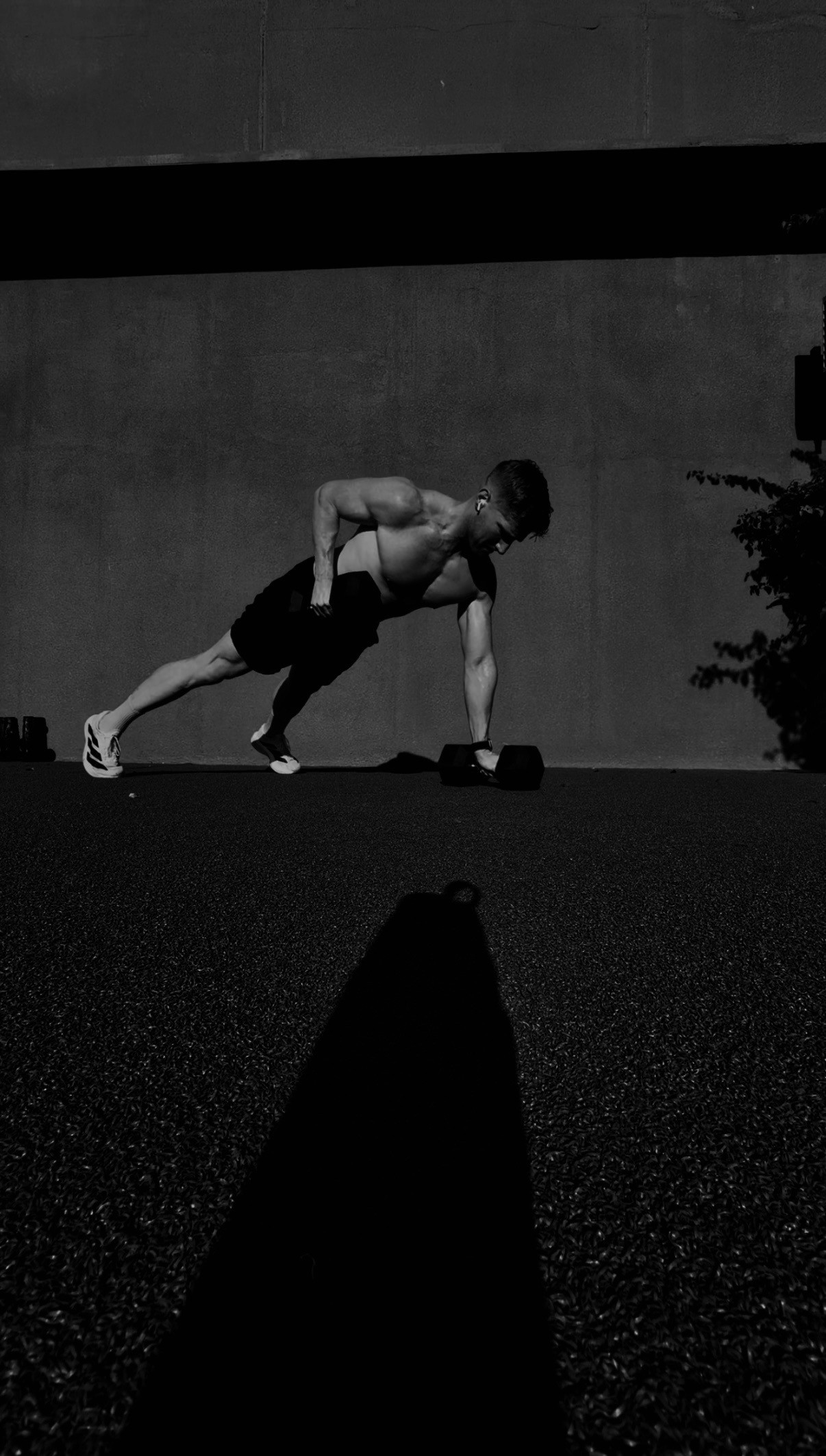 A coaching client training outdoors, in black and white