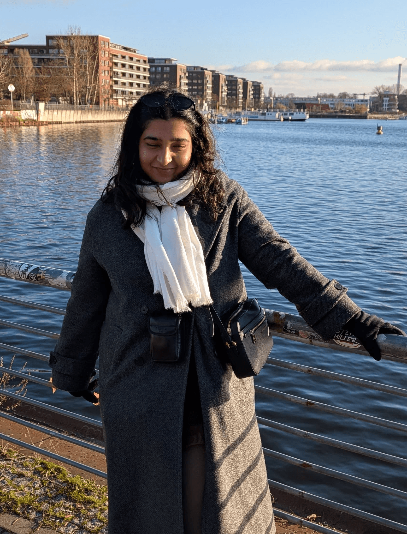 A thoughtful young person with dark hair gazes to the side, captured in soft black and white lighting.