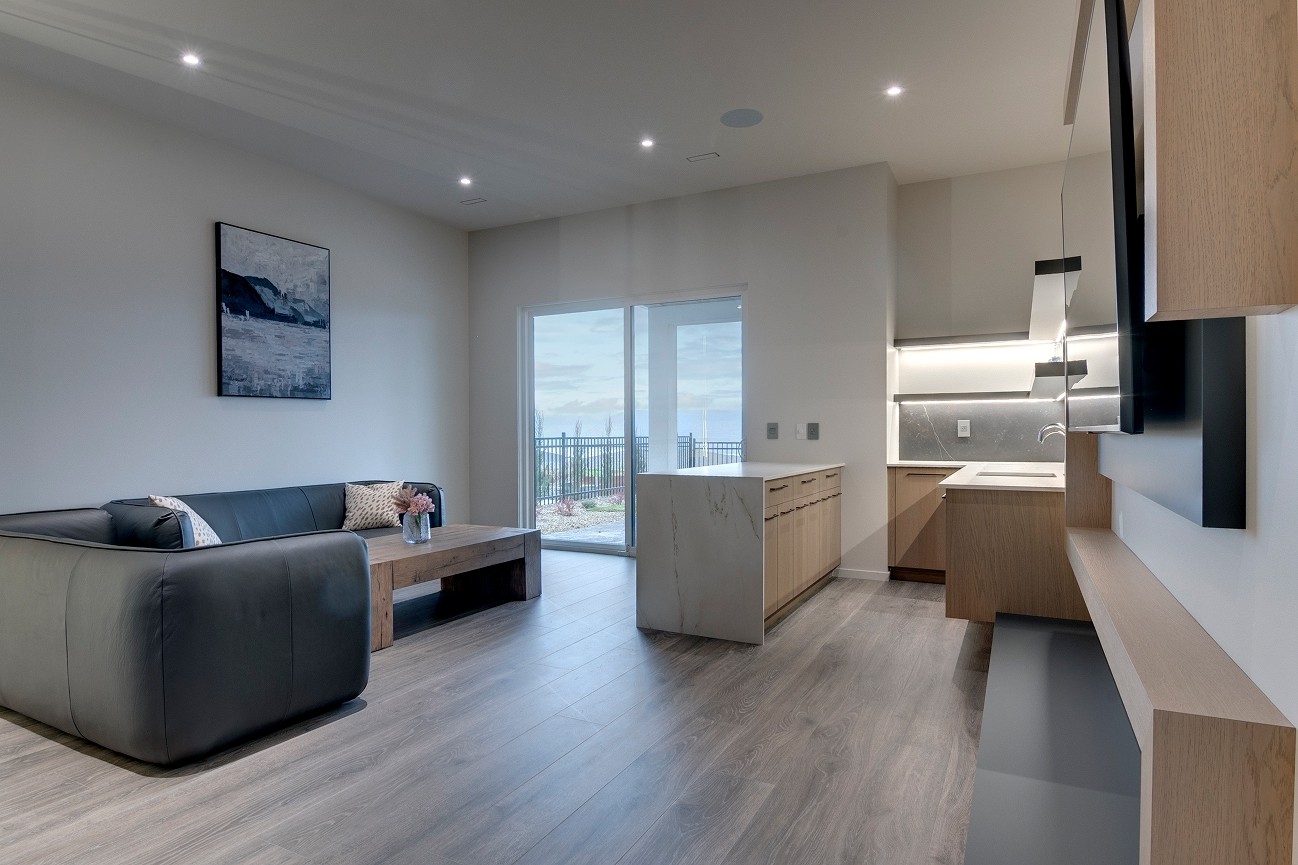 Spacious living area with large windows and wood flooring