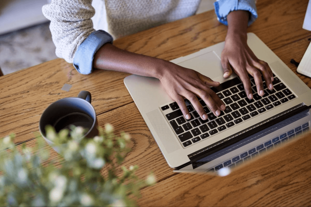 SaaS sales funnel: Woman typing on her laptop