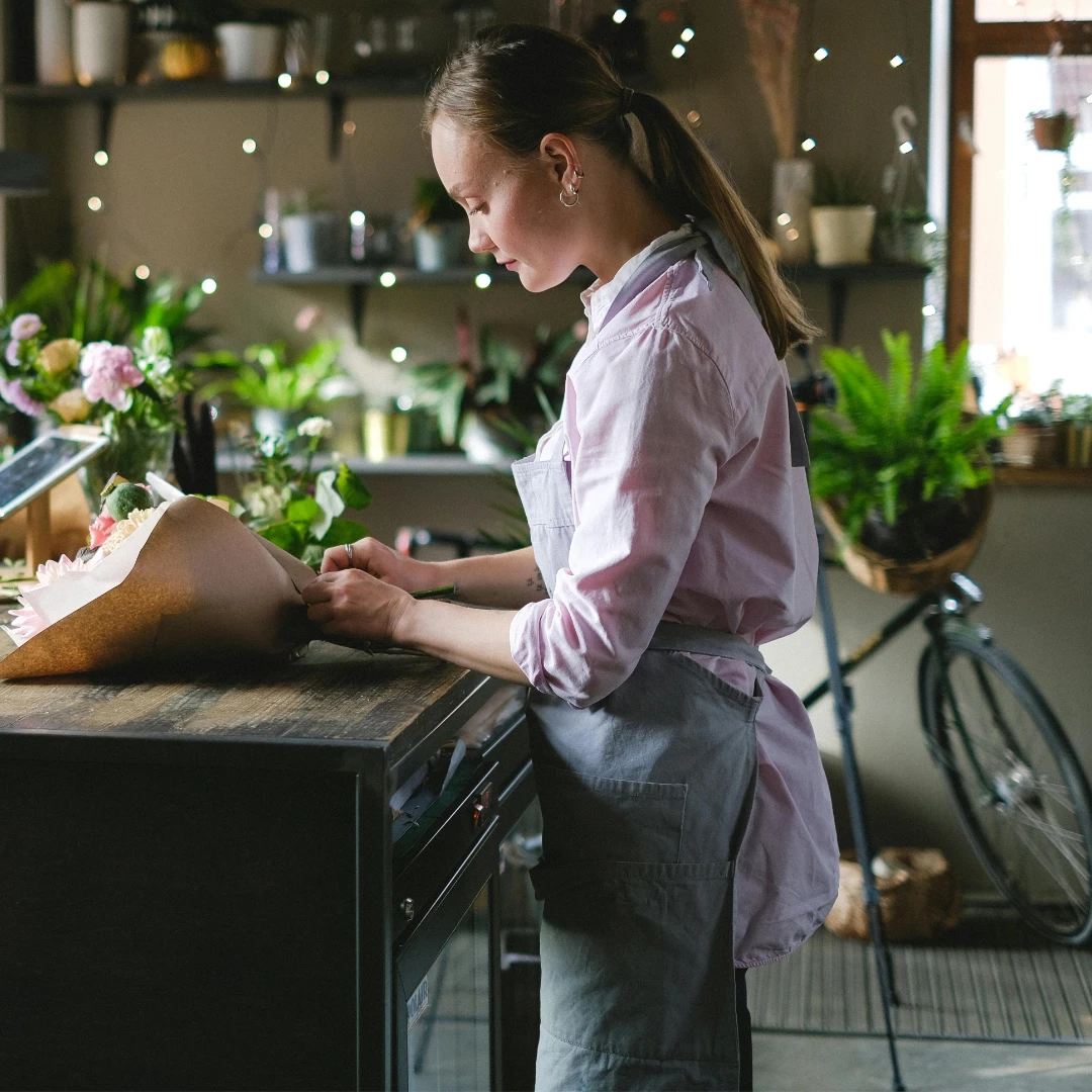 Florist cutting flowers in studio