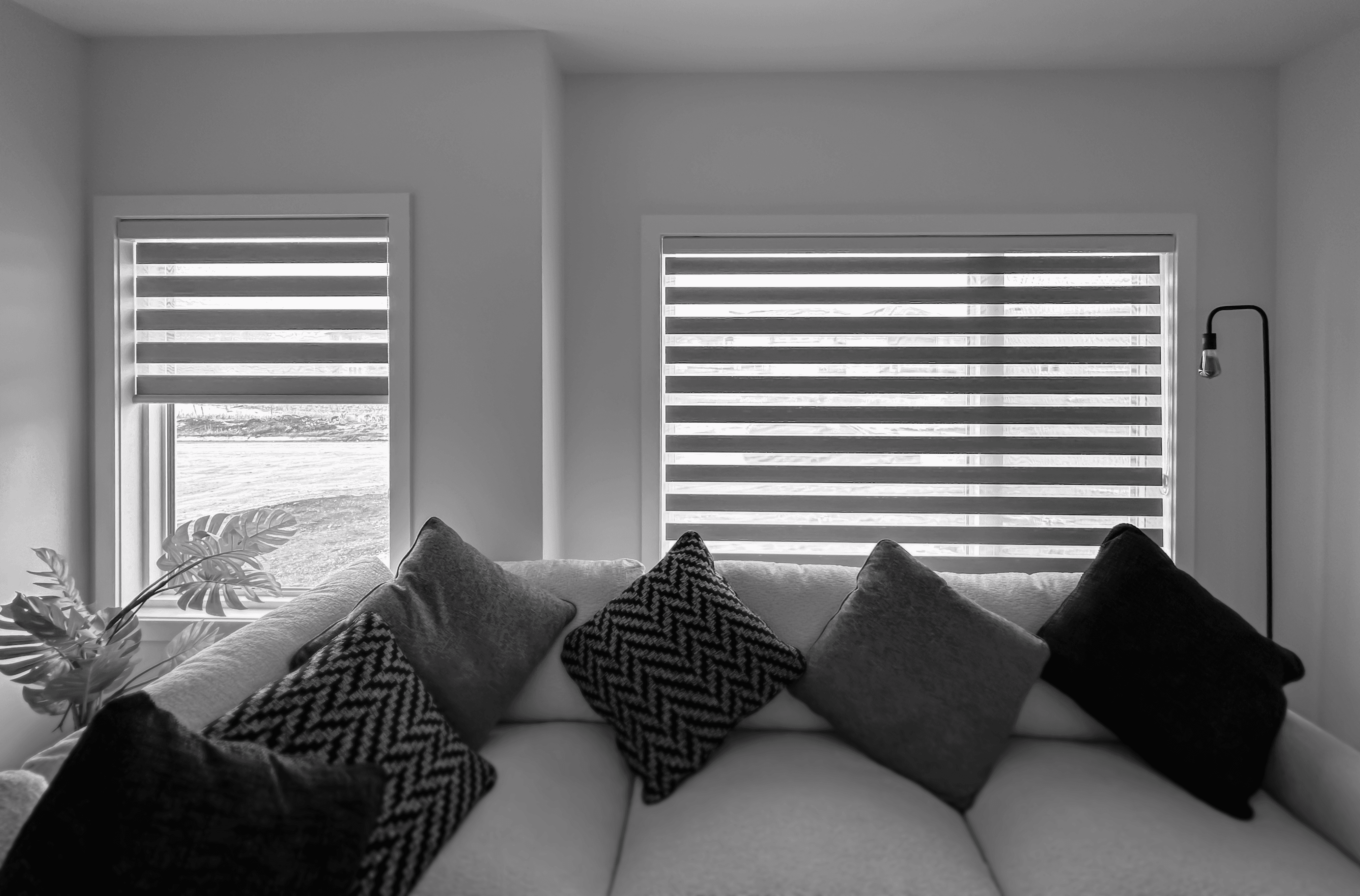 a beautiful living room filled with amazing decor and sofa set with zebra blinds in the back offering perfect light filtering depending on the mood.