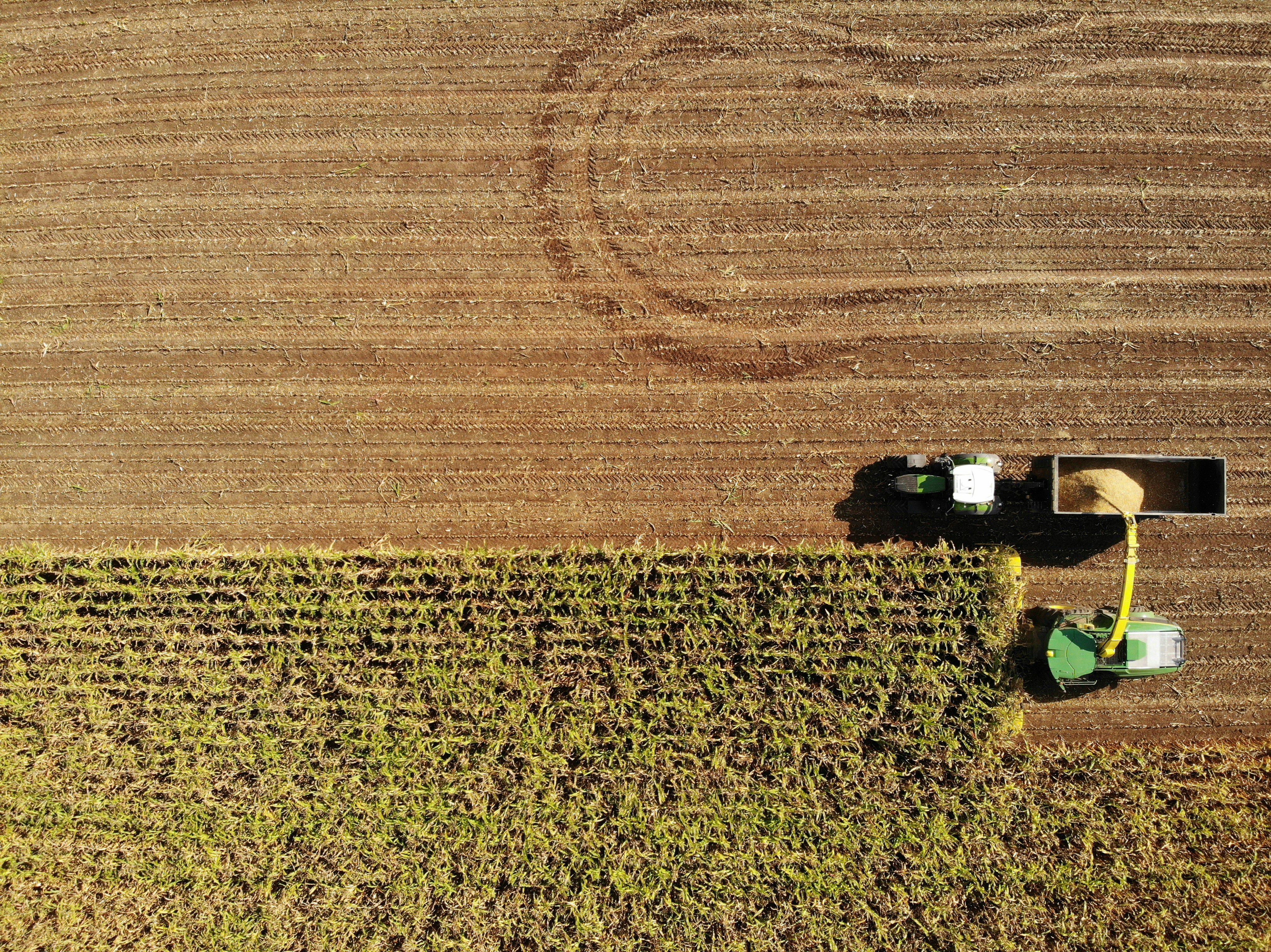 an aerial view of a tractor in a field