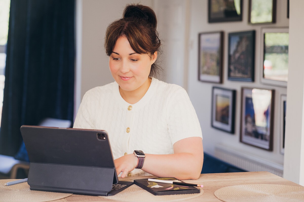 Aniko Rucz working on short-term rental systems and operations using a tablet at home